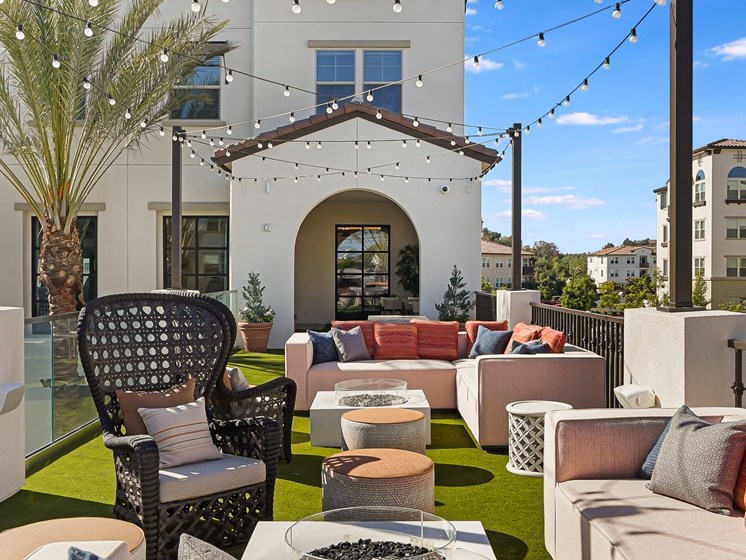 Outdoor Entertaining Space with Twinkle Lights and Firepits at The Club at Enclave Apartments in Chula Vista, CA
