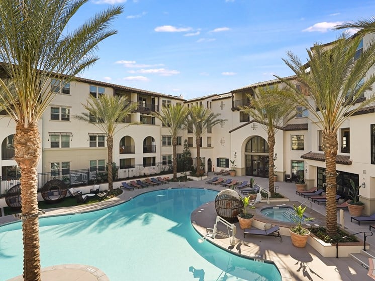 Resort Pool and Hot Tub with Palm Trees and Modern Outdoor Seating Areas at The Club at Enclave Apartments in Chula Vista, CA