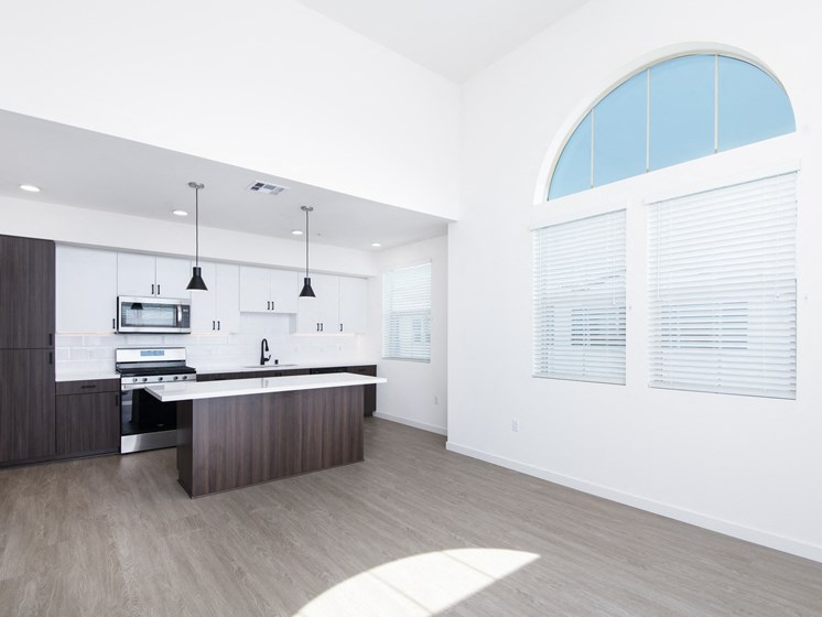 Modern Kitchen With Wood Flooring At The Club At Enclave Apartments In Chula Vista, CA