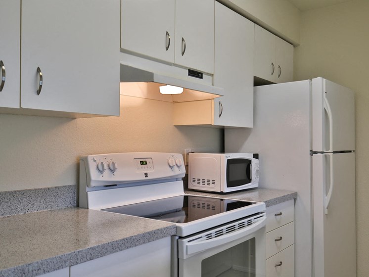 Kitchen With White Cabinetry And Appliances at Charbonneau, Seattle, 98101