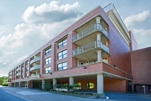 a large brick building with a street in front of it