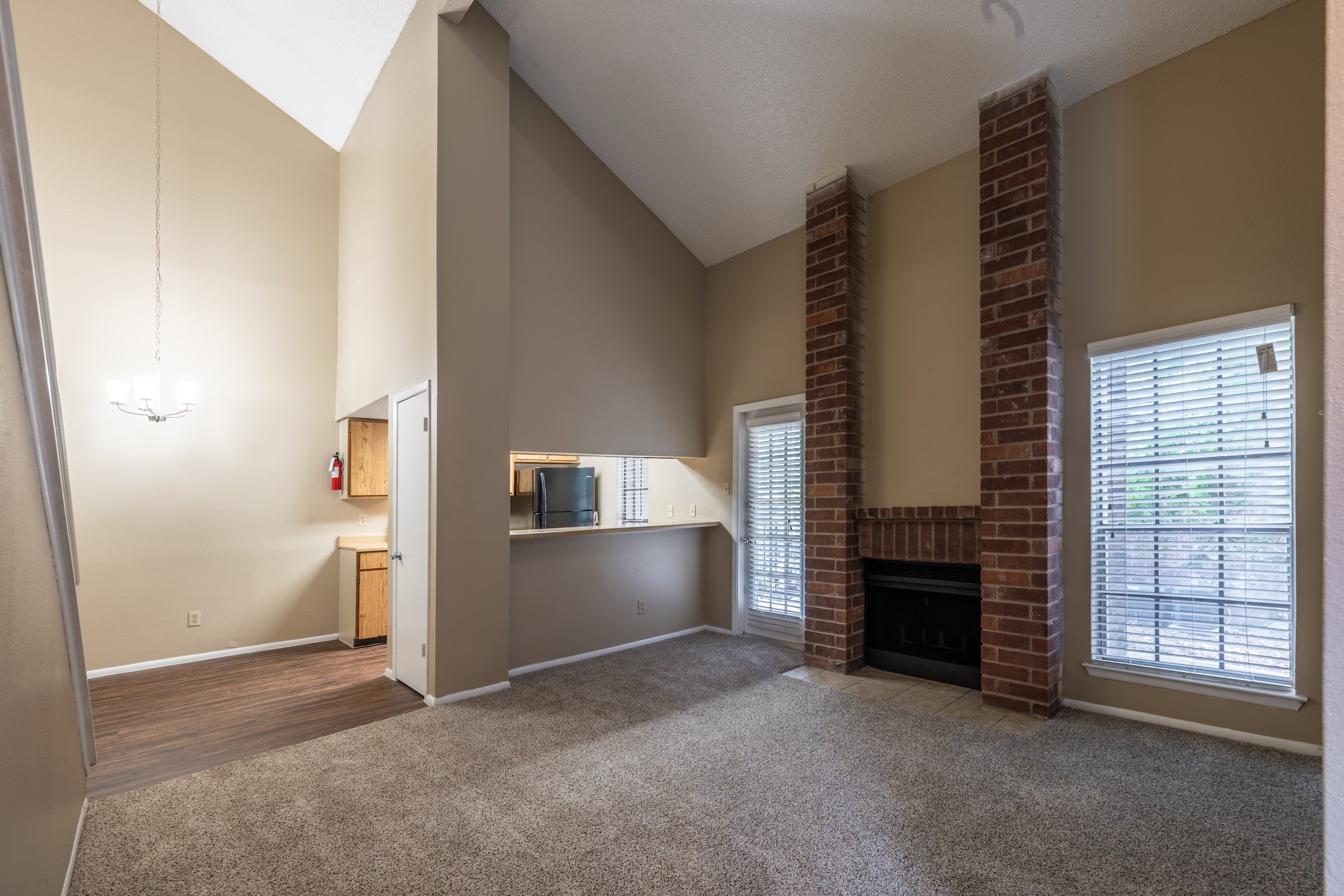 A living room with a fireplace and a television.