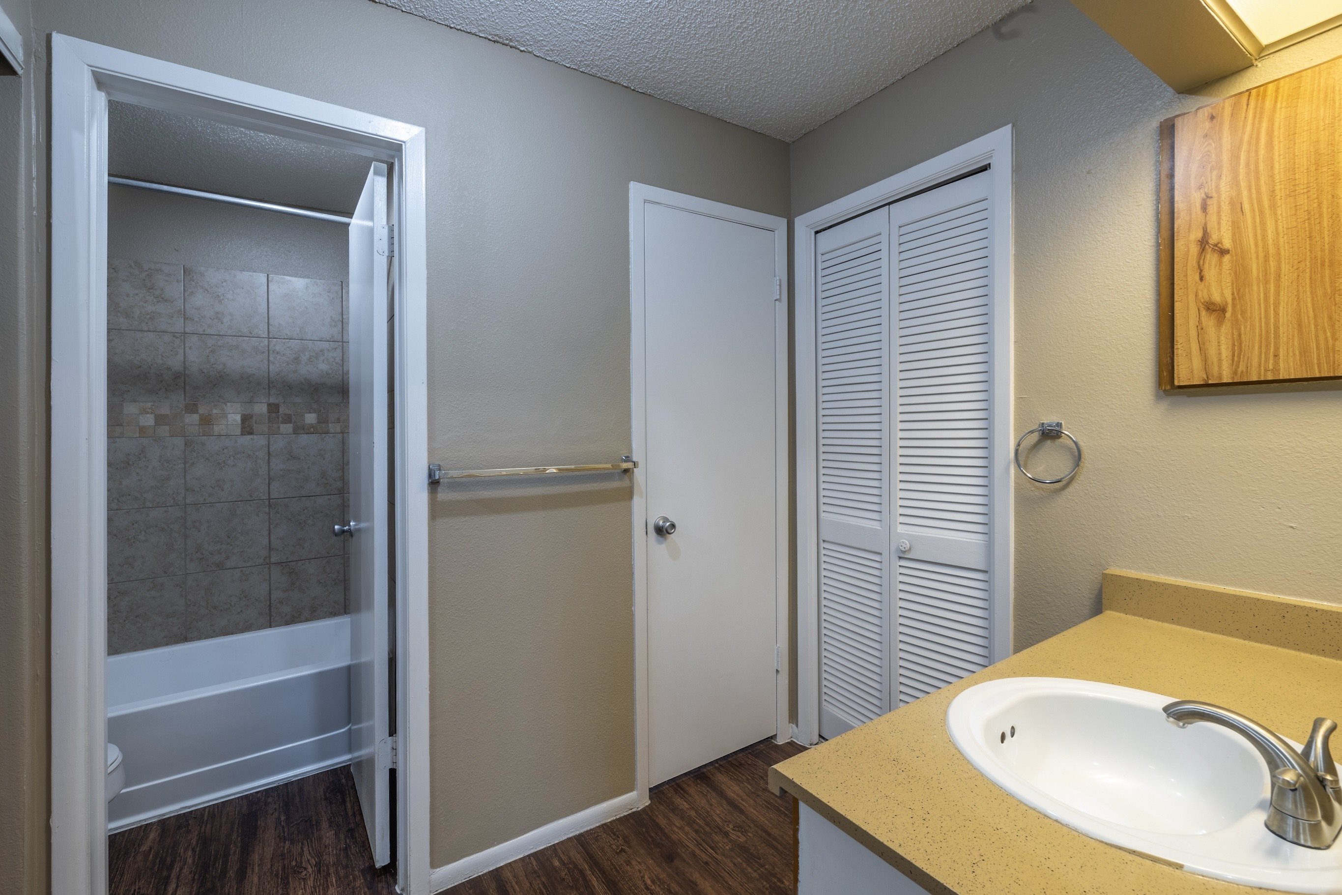 A bathroom with a sink, toilet, and shower.