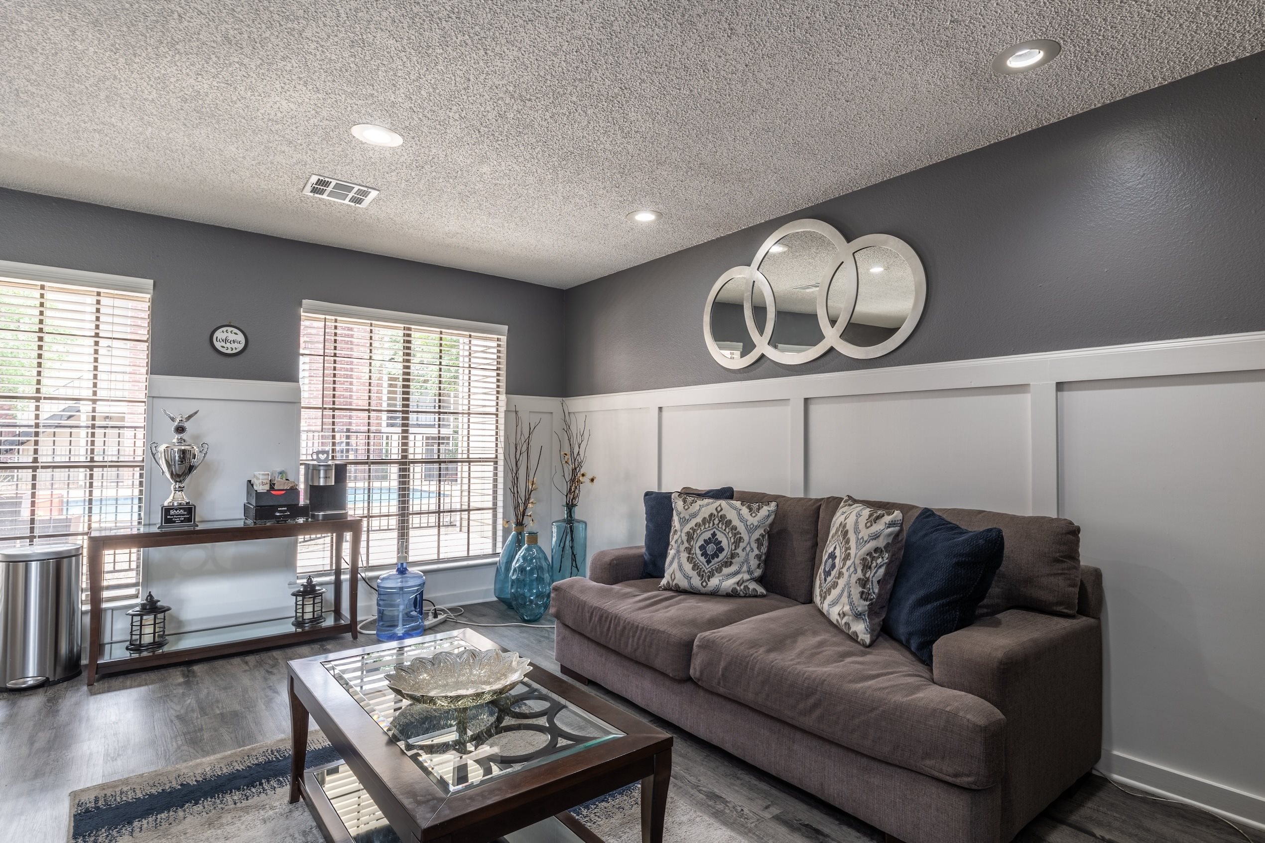 A living room with a brown couch and a coffee table.