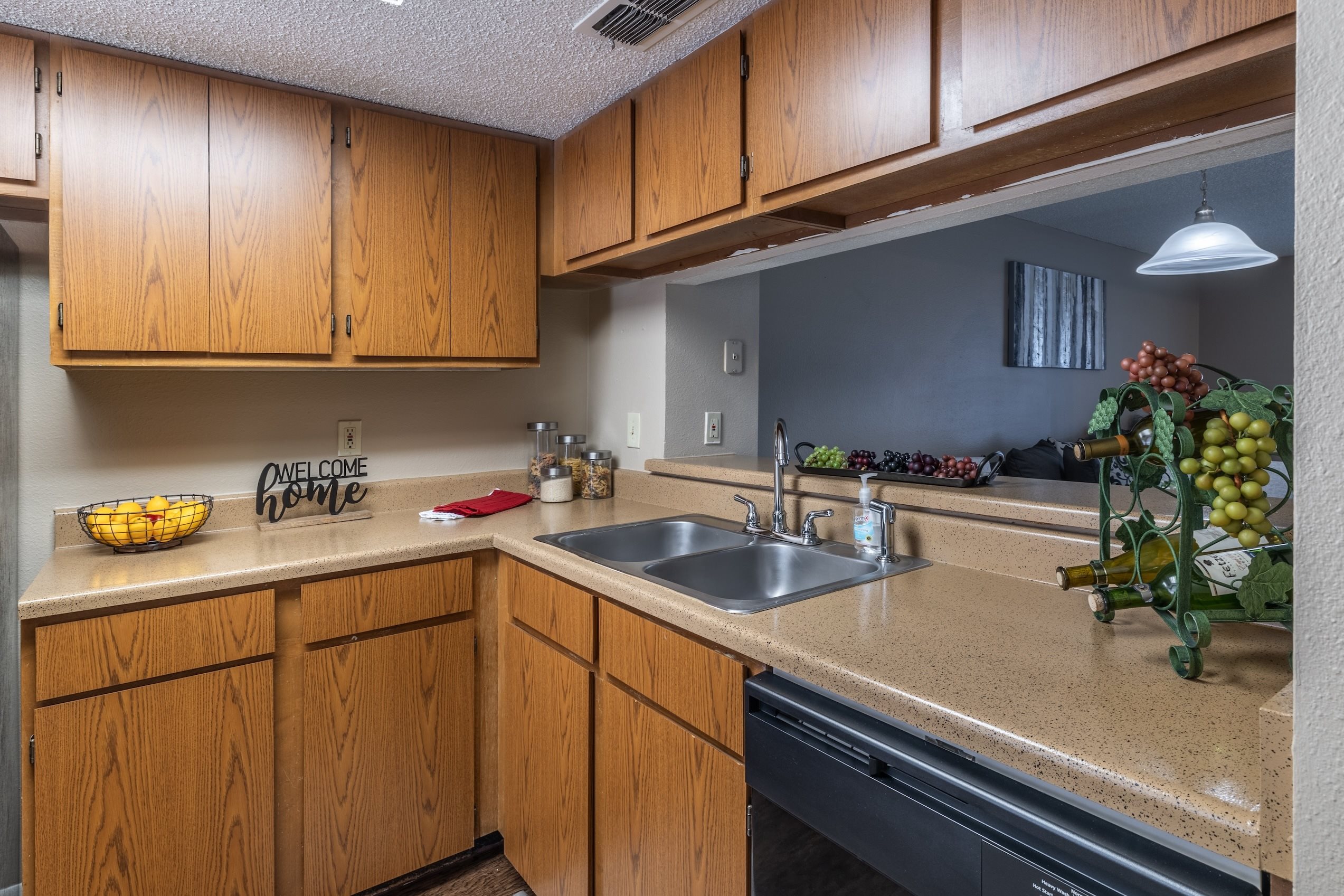 A kitchen with wooden cabinets and a sink.
