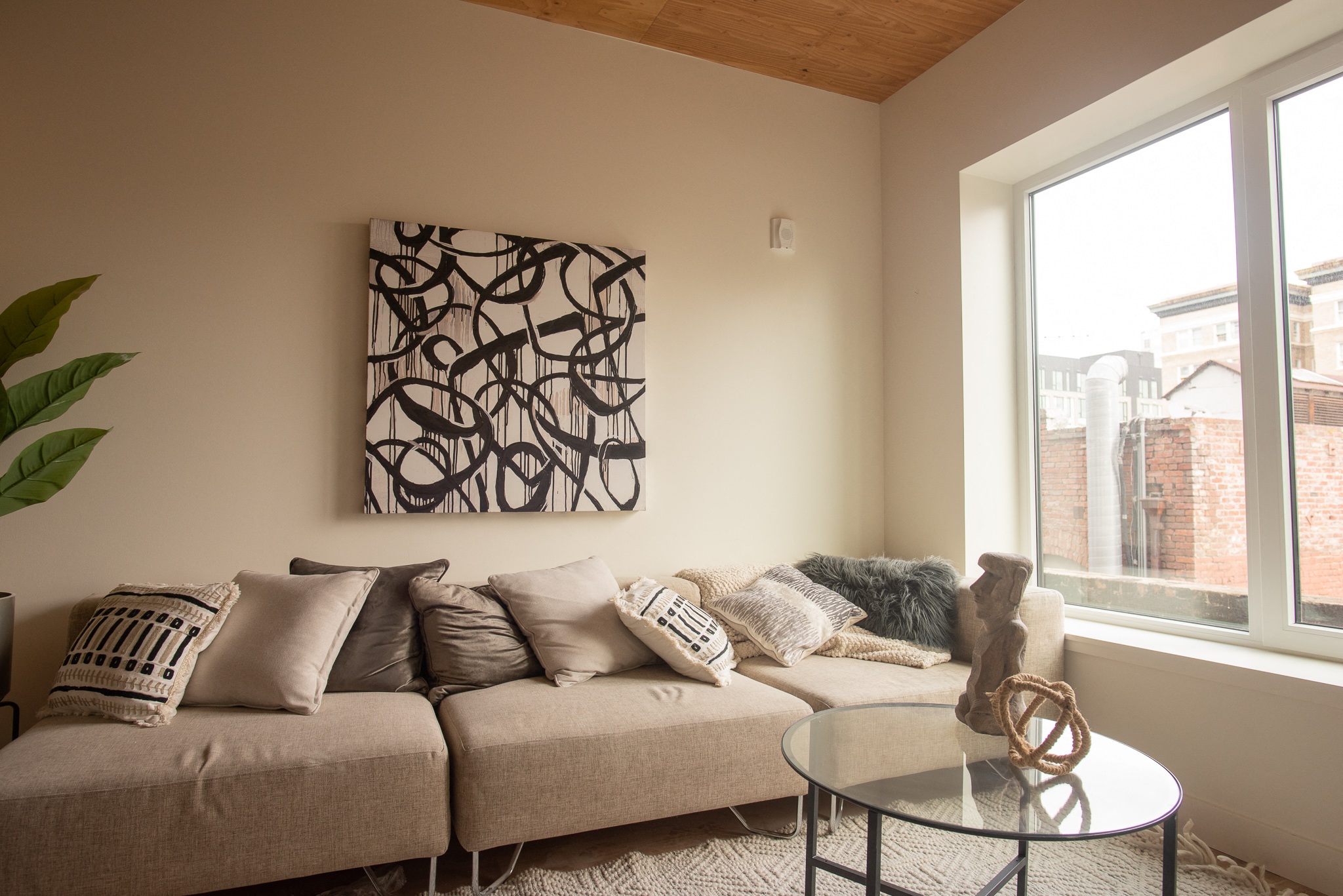 a living room with a couch and a glass table