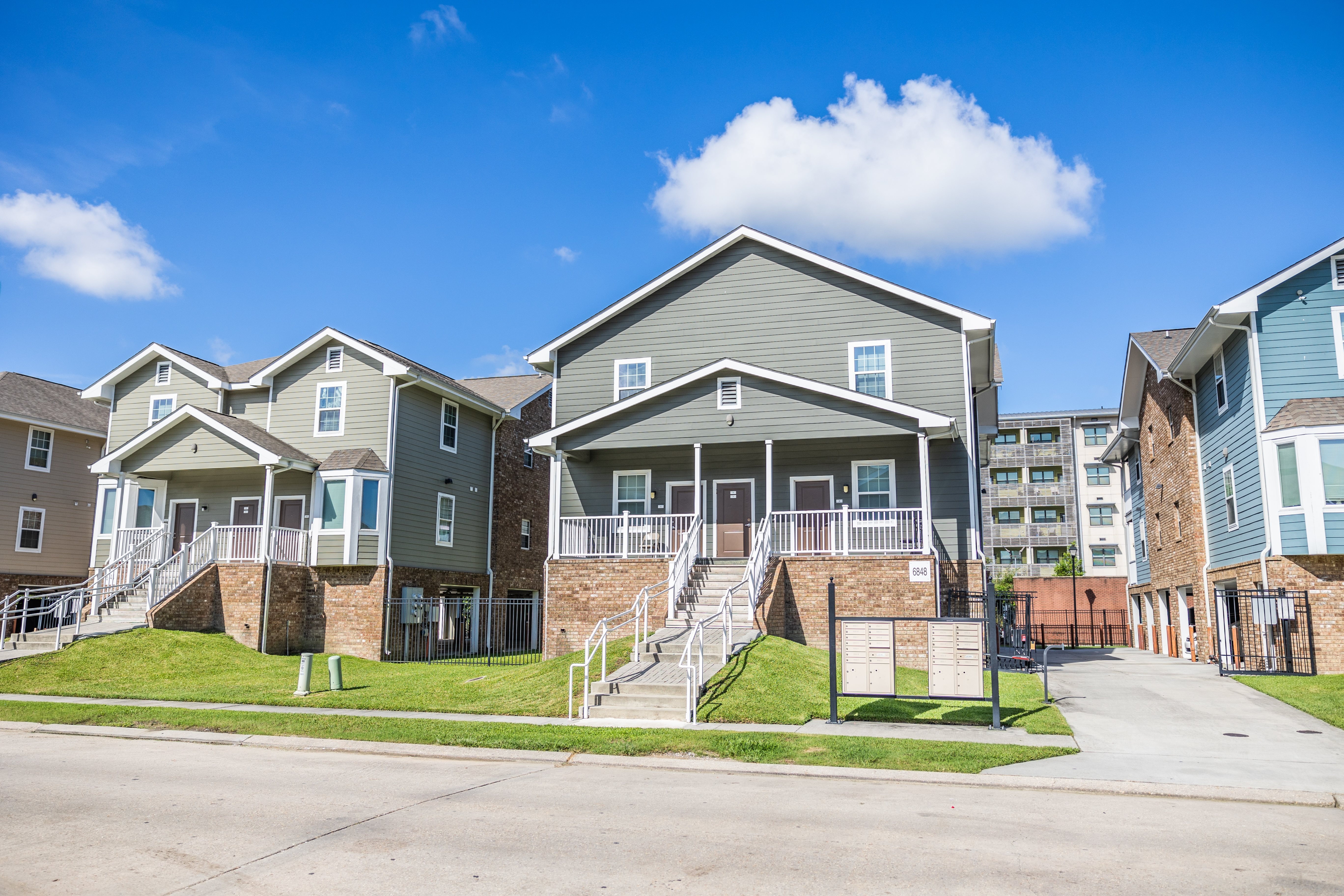 A row of houses with a clear blue sky above them.