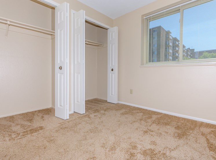 Standard unit master bedroom with carpeting and double closets