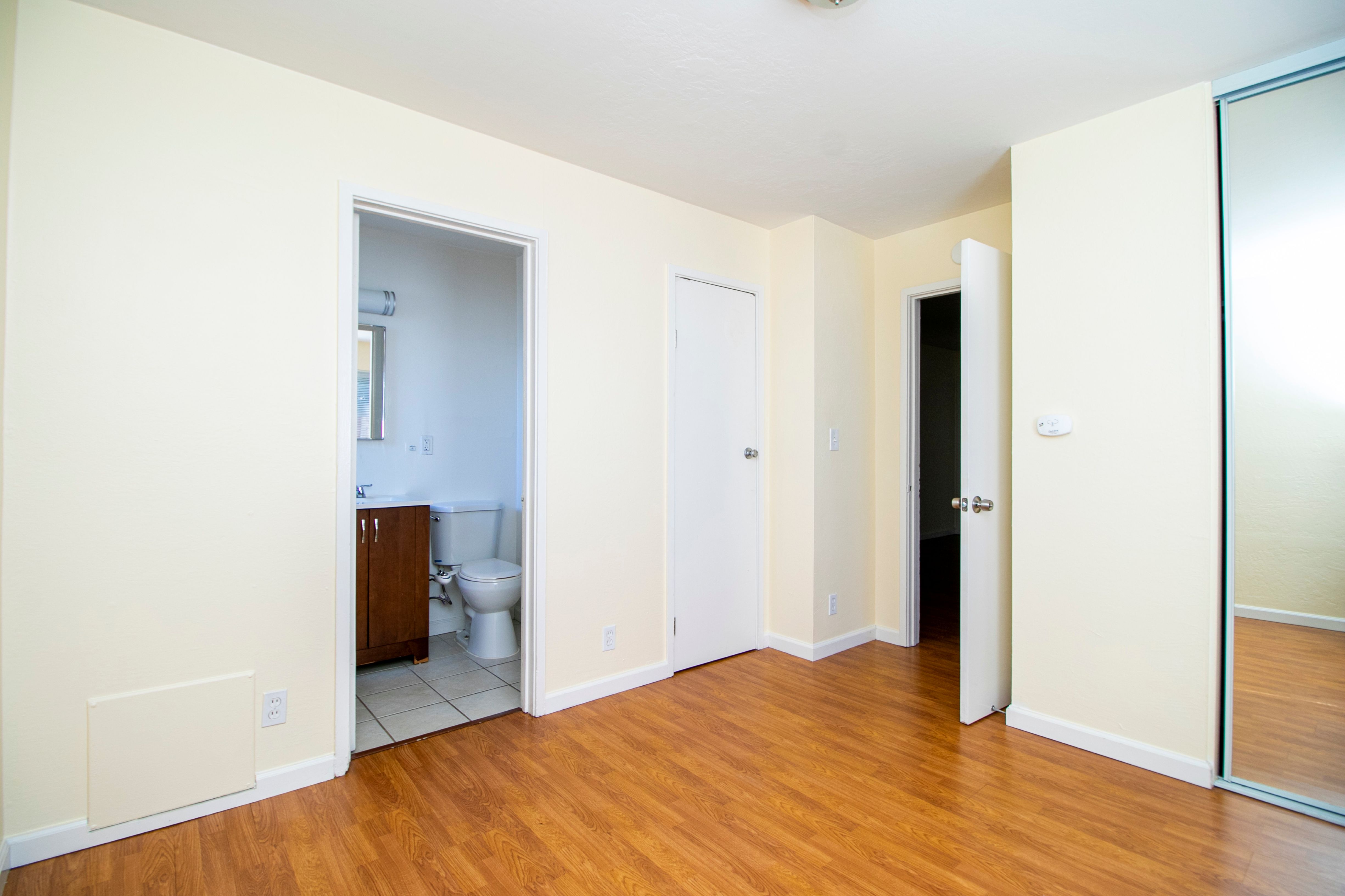A room with a wooden floor and white walls.