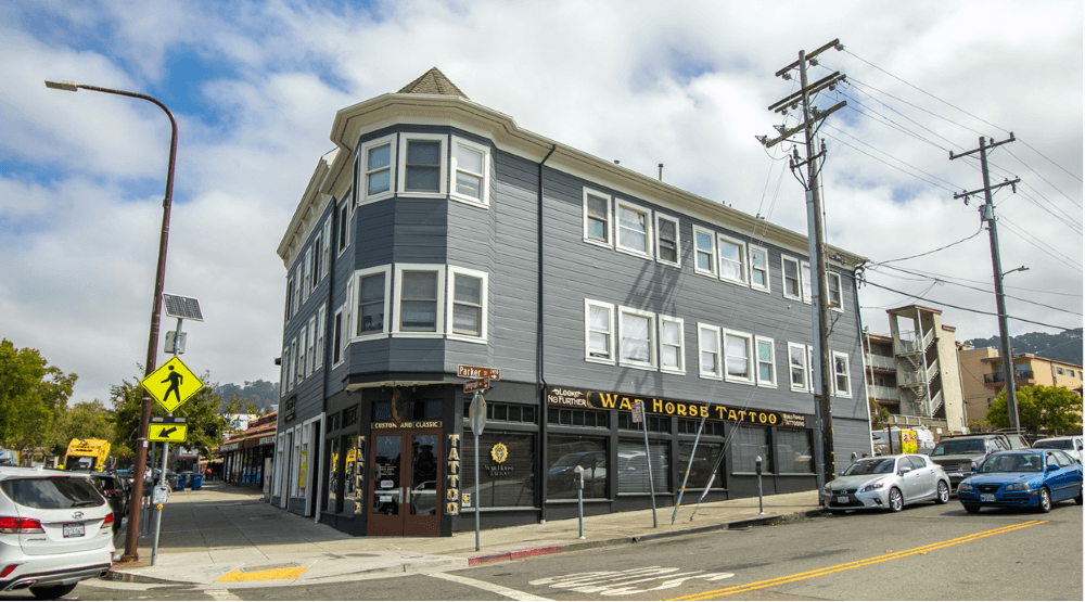 A street view of a building with the sign "War Horse Tattoo" on it.