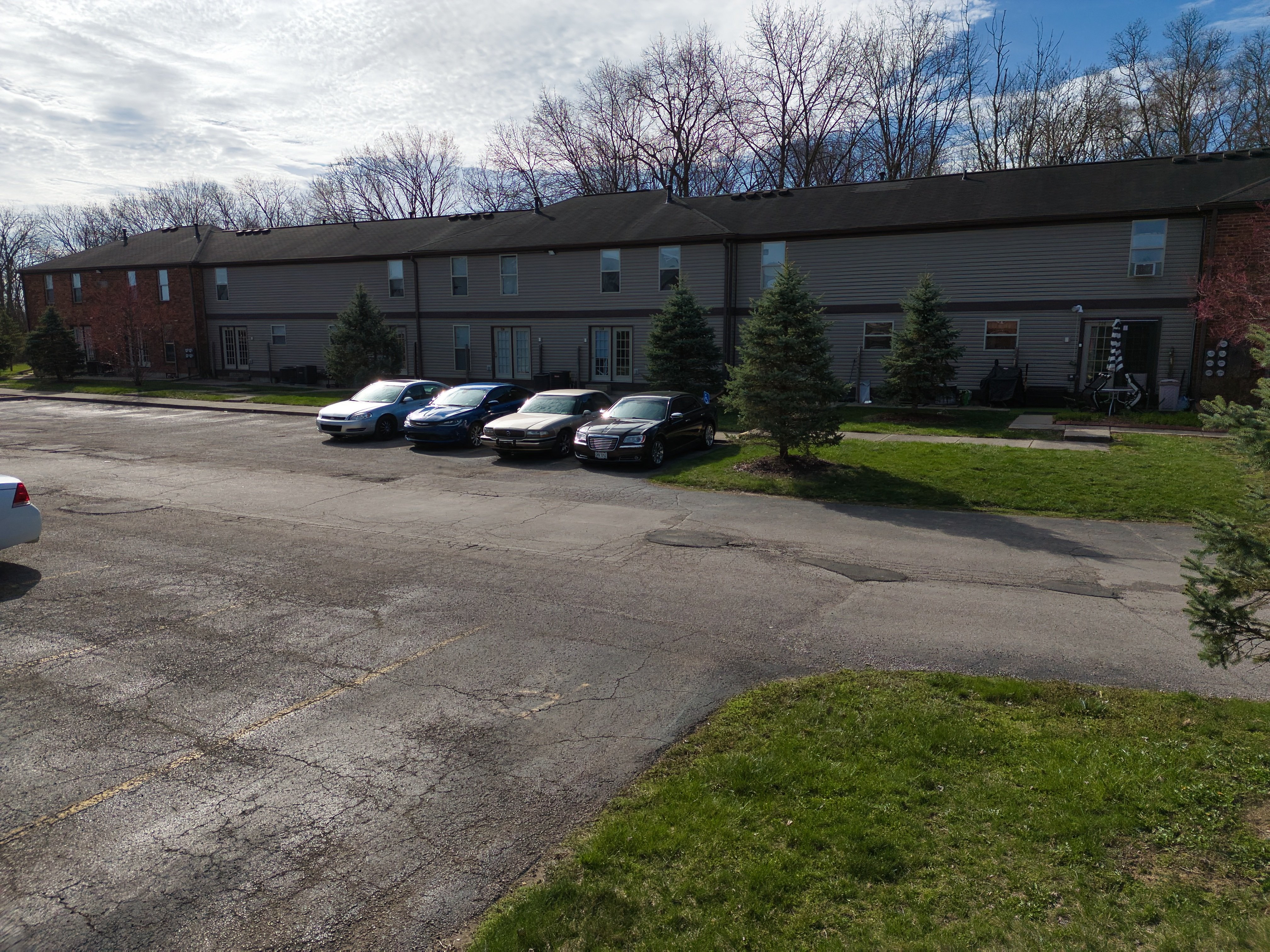 a parking lot with cars in front of a building