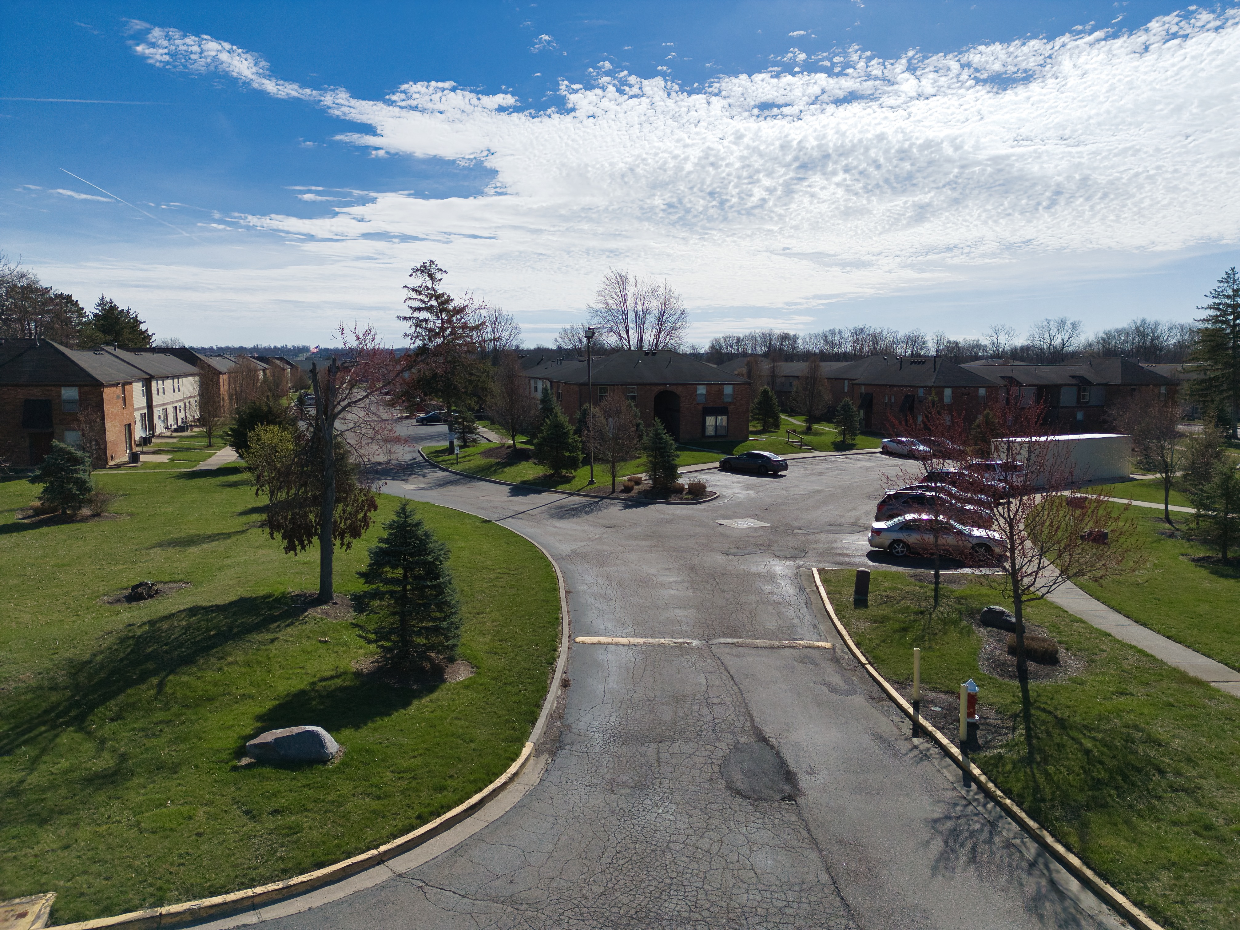 an aerial view of a neighborhood with a road and houses