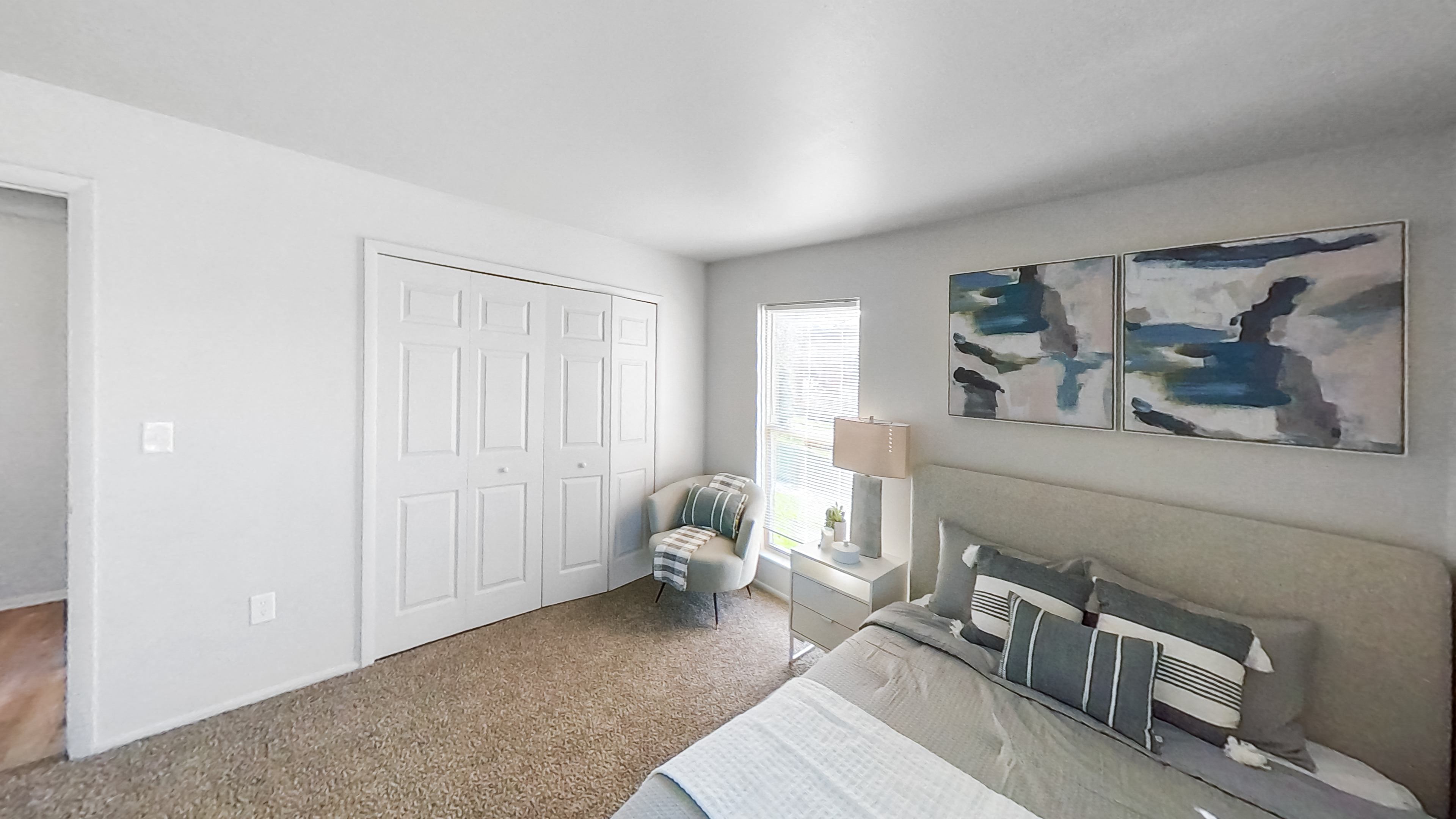 an open living room with a couch and a window