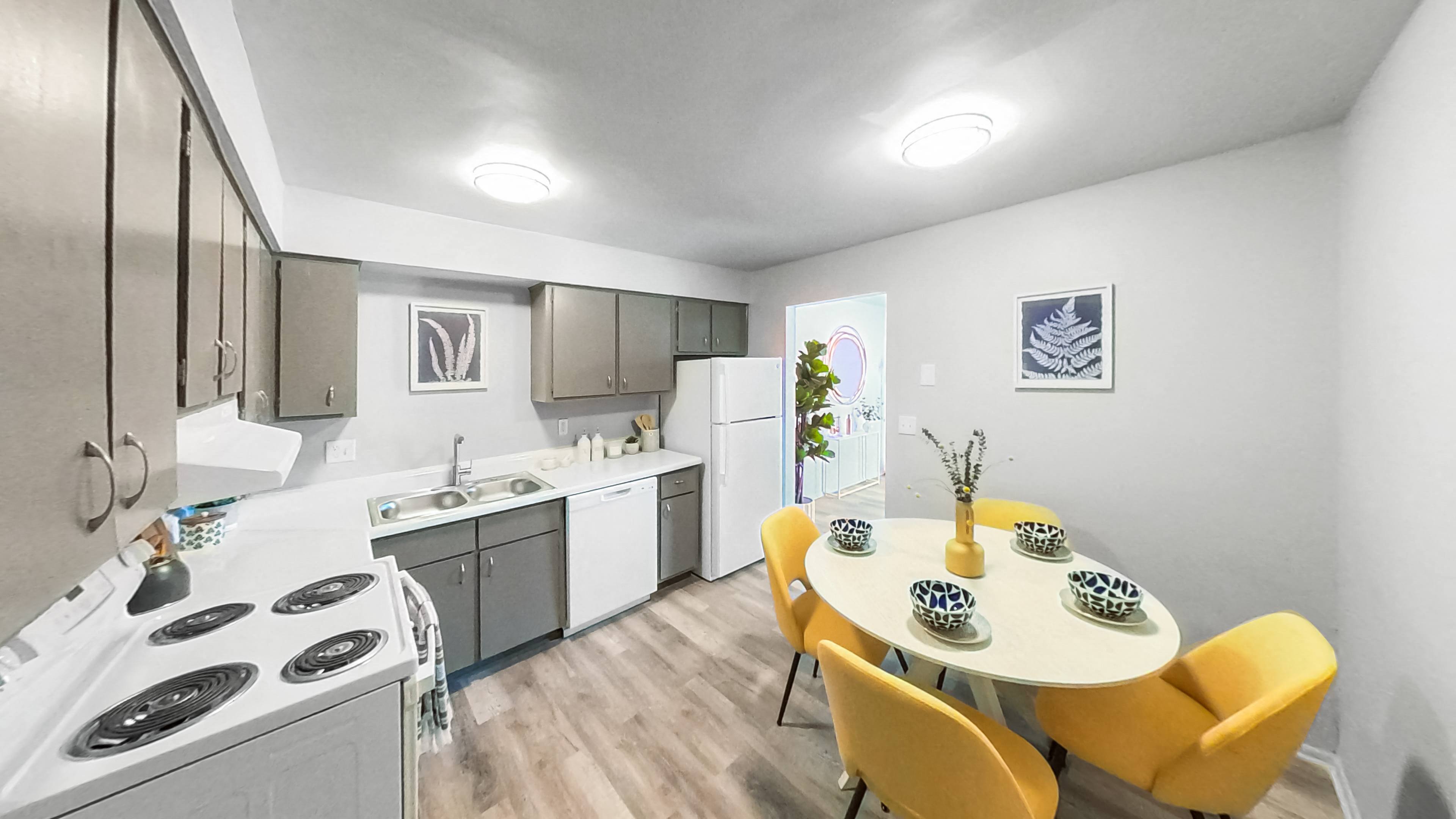 a kitchen and dining room with a table and chairs