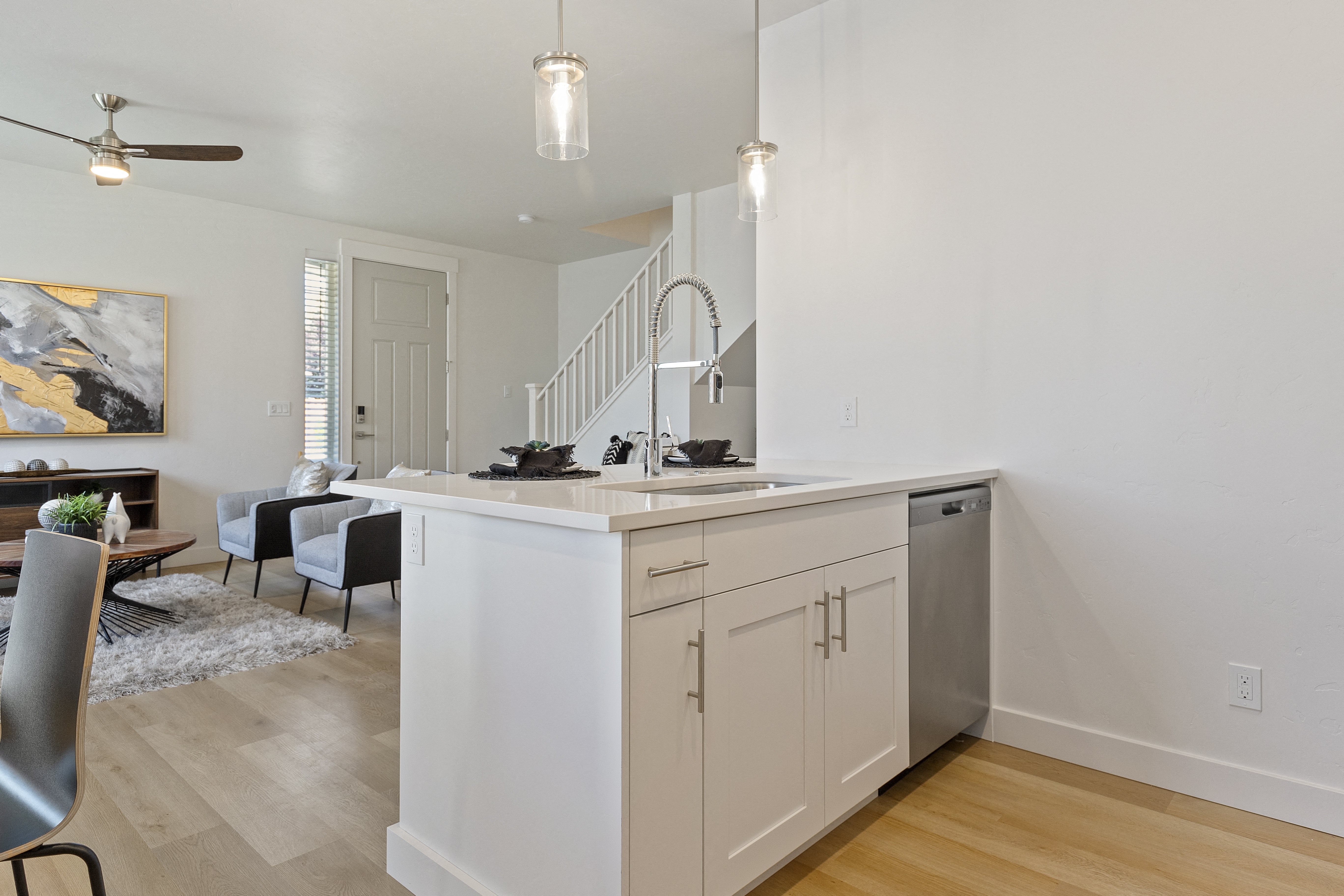 a kitchen and living room with a staircase at Alante Homes at Lake Hazel, Idaho, 83709