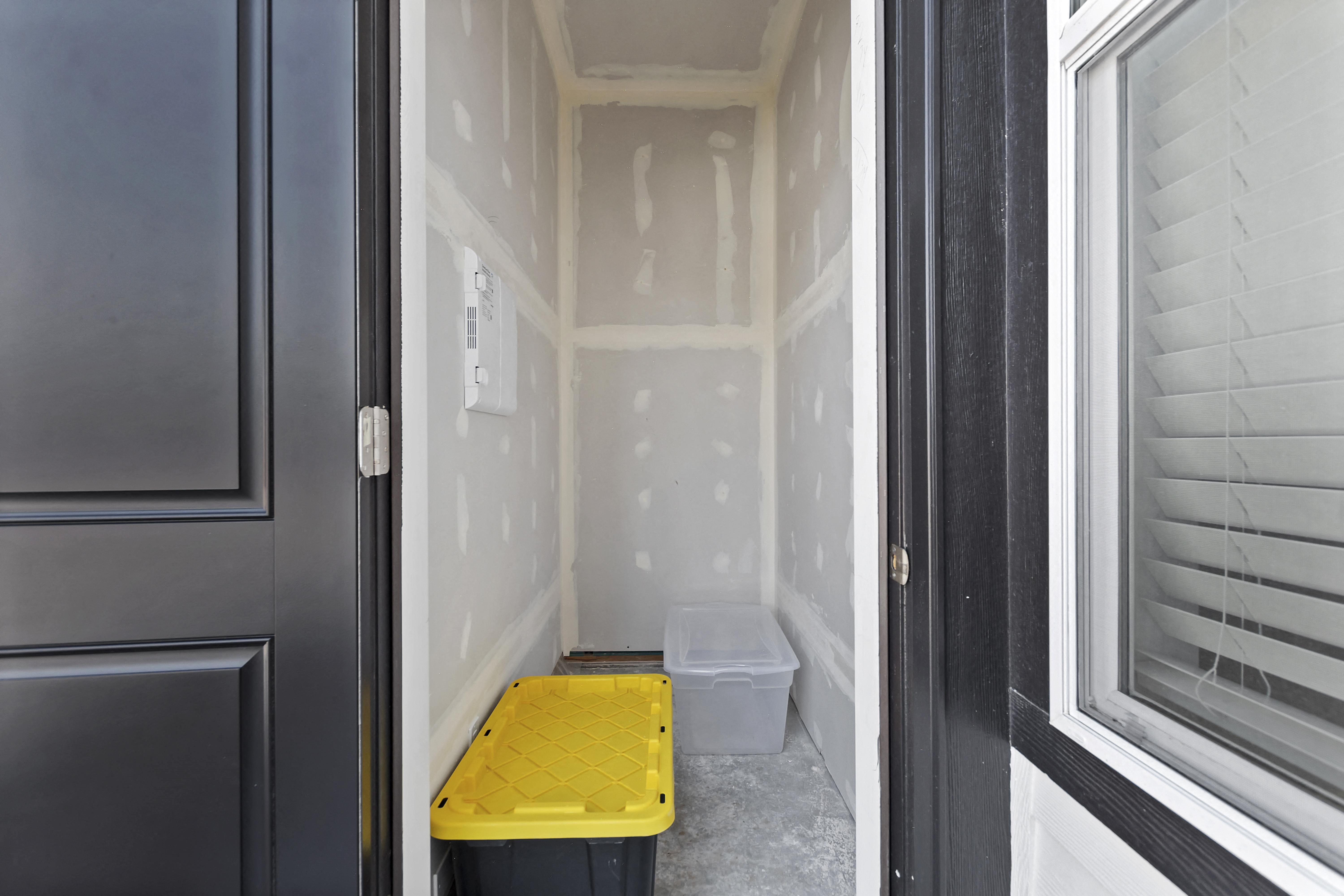 an empty room with a yellow litter box in the corner at Alante Homes at Lake Hazel, Boise