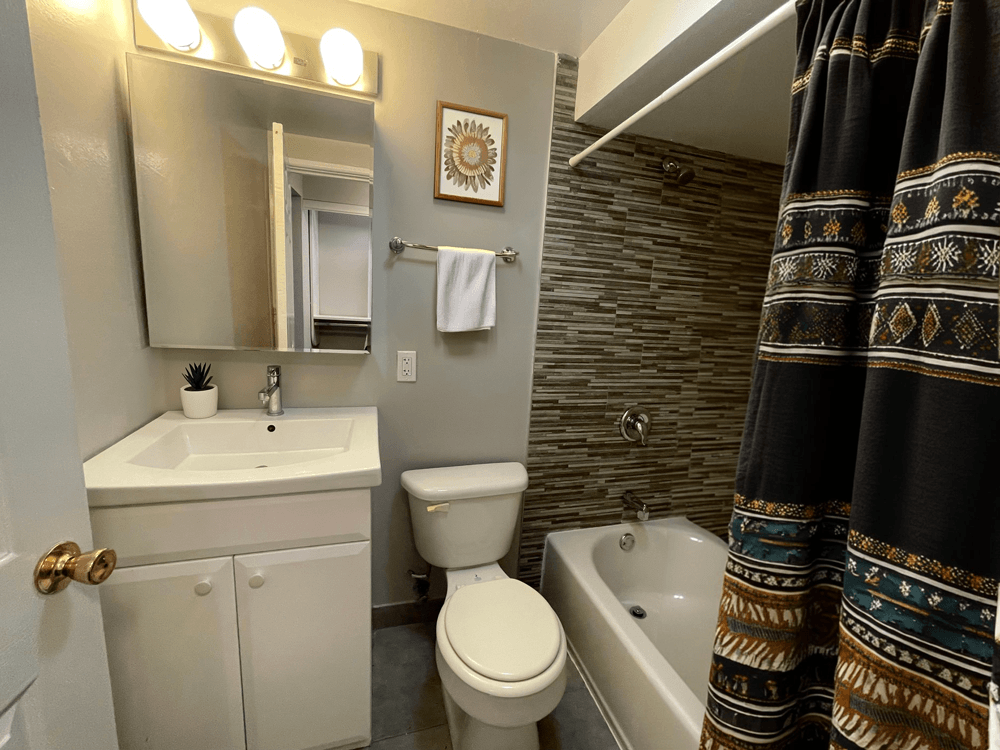 a bathroom with a sink toilet and bath tub