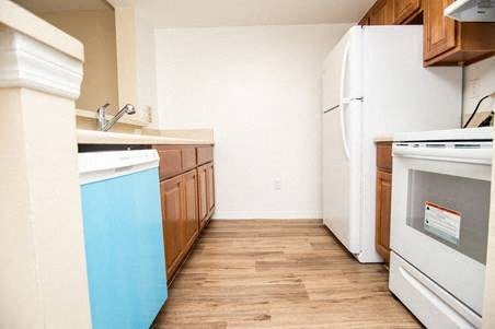 Wood-style flooring and new white appliances