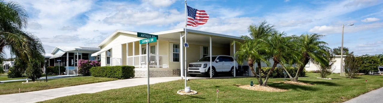 A house with a flag on the front lawn.