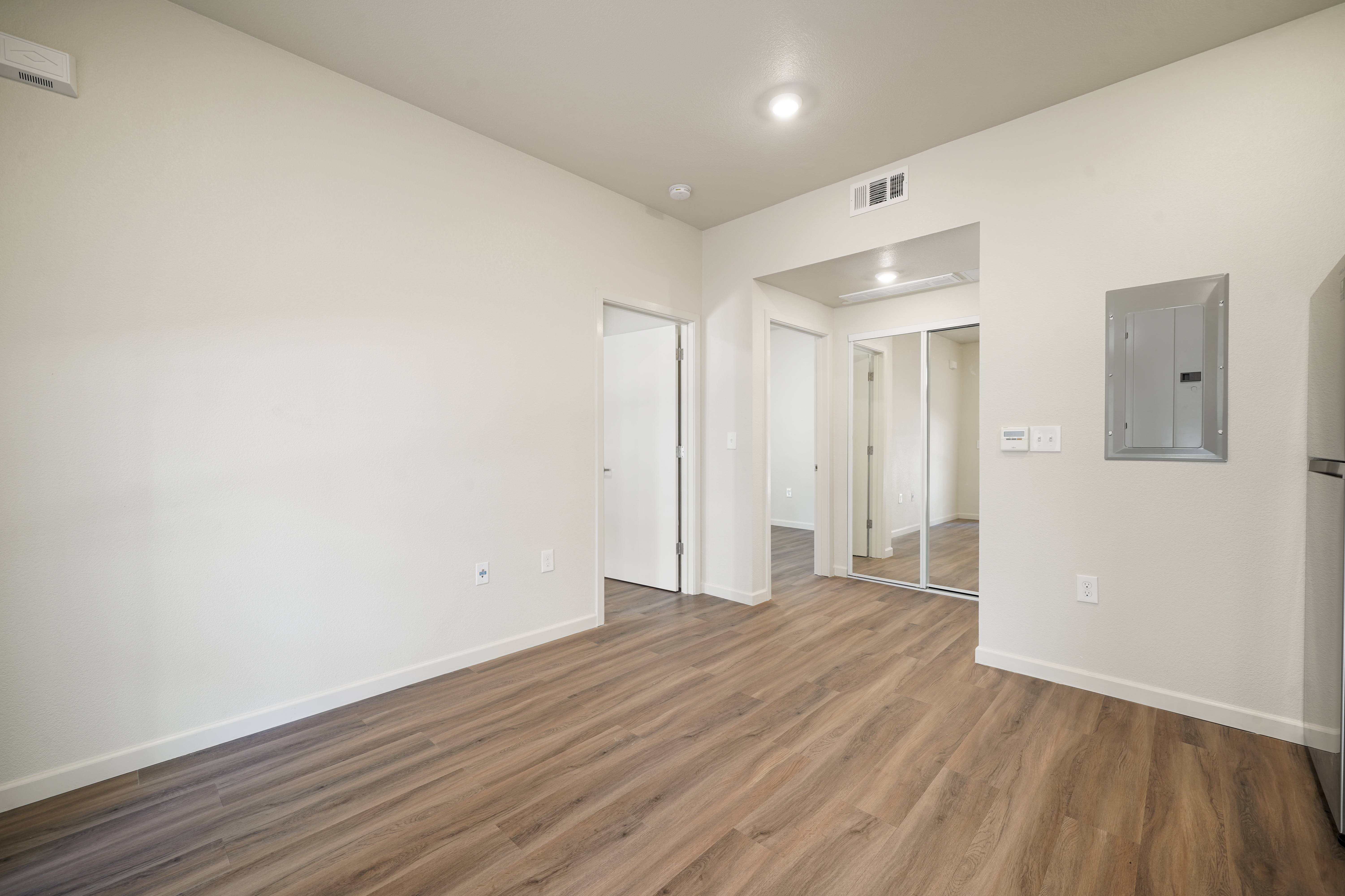 A room with wooden floors and white walls.
