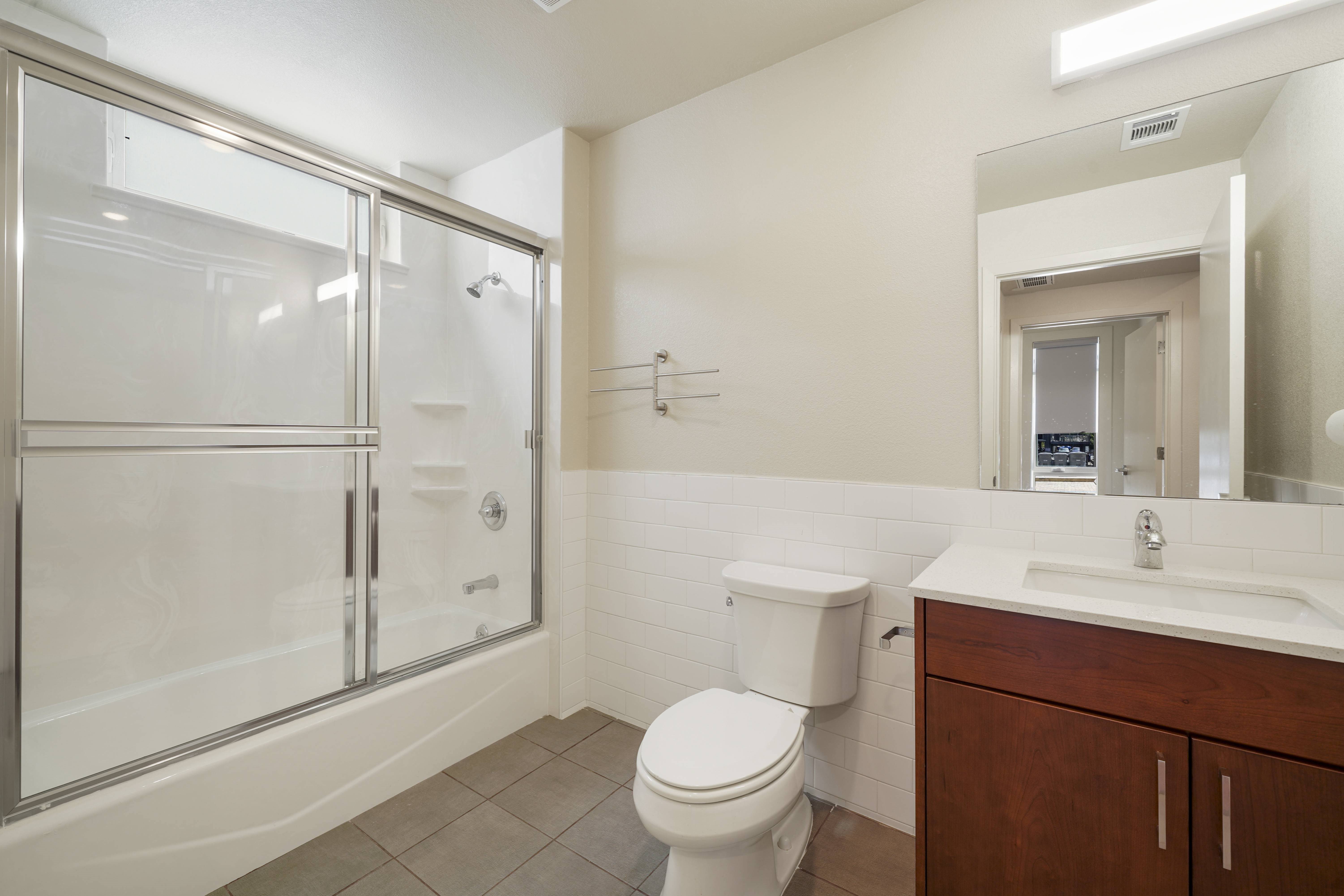 A white toilet sits next to a sink in a bathroom.