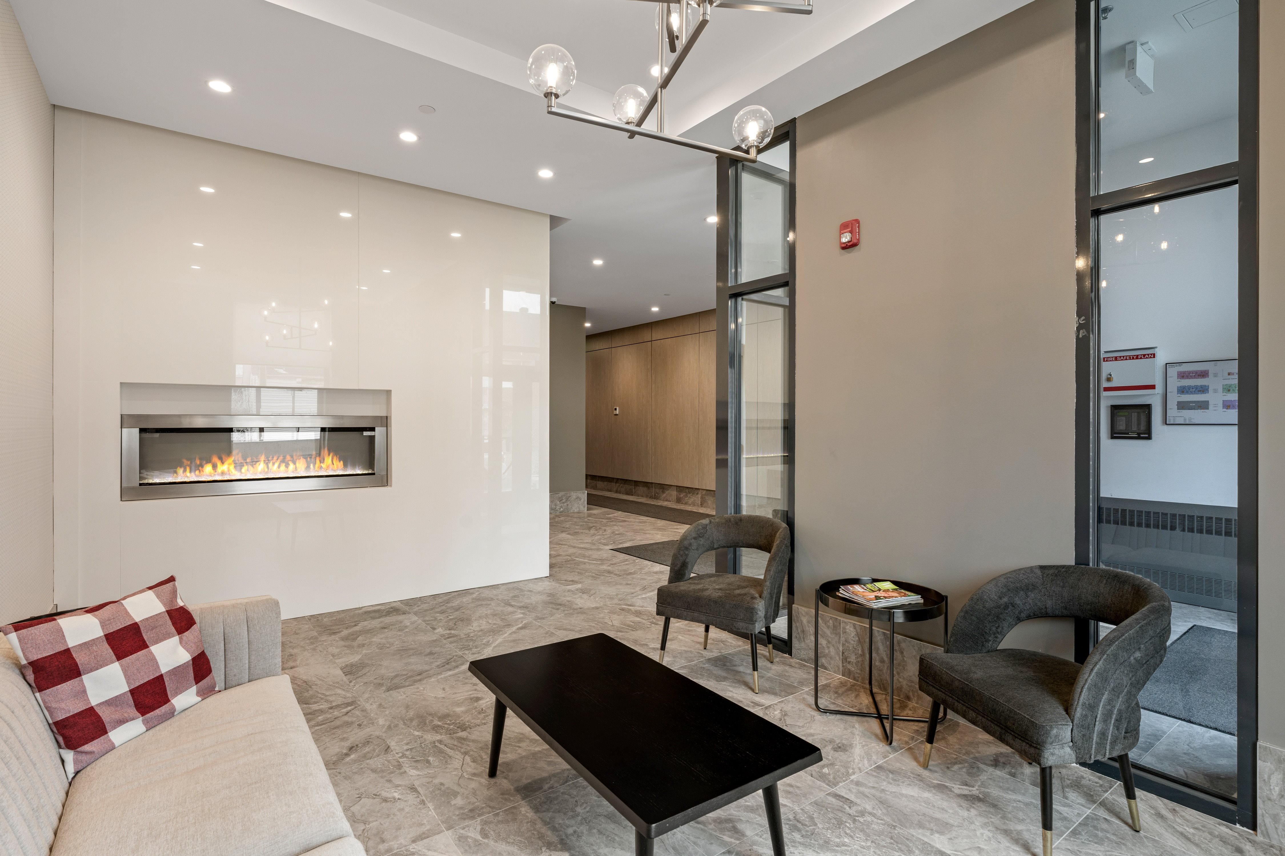 A modern living room with a fireplace and comfortable seating.