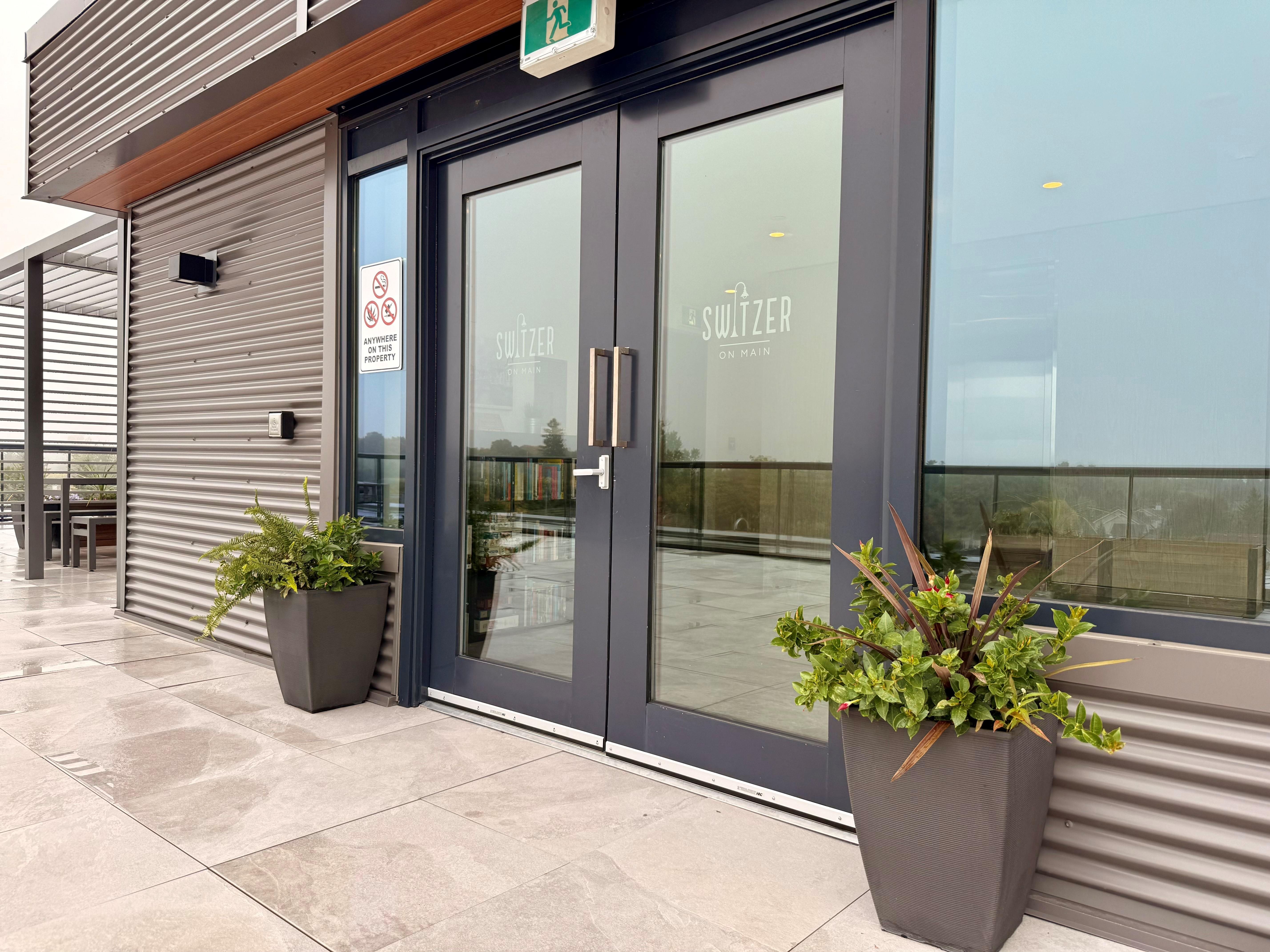 A building with a glass door and a sign that says "Switzerland".