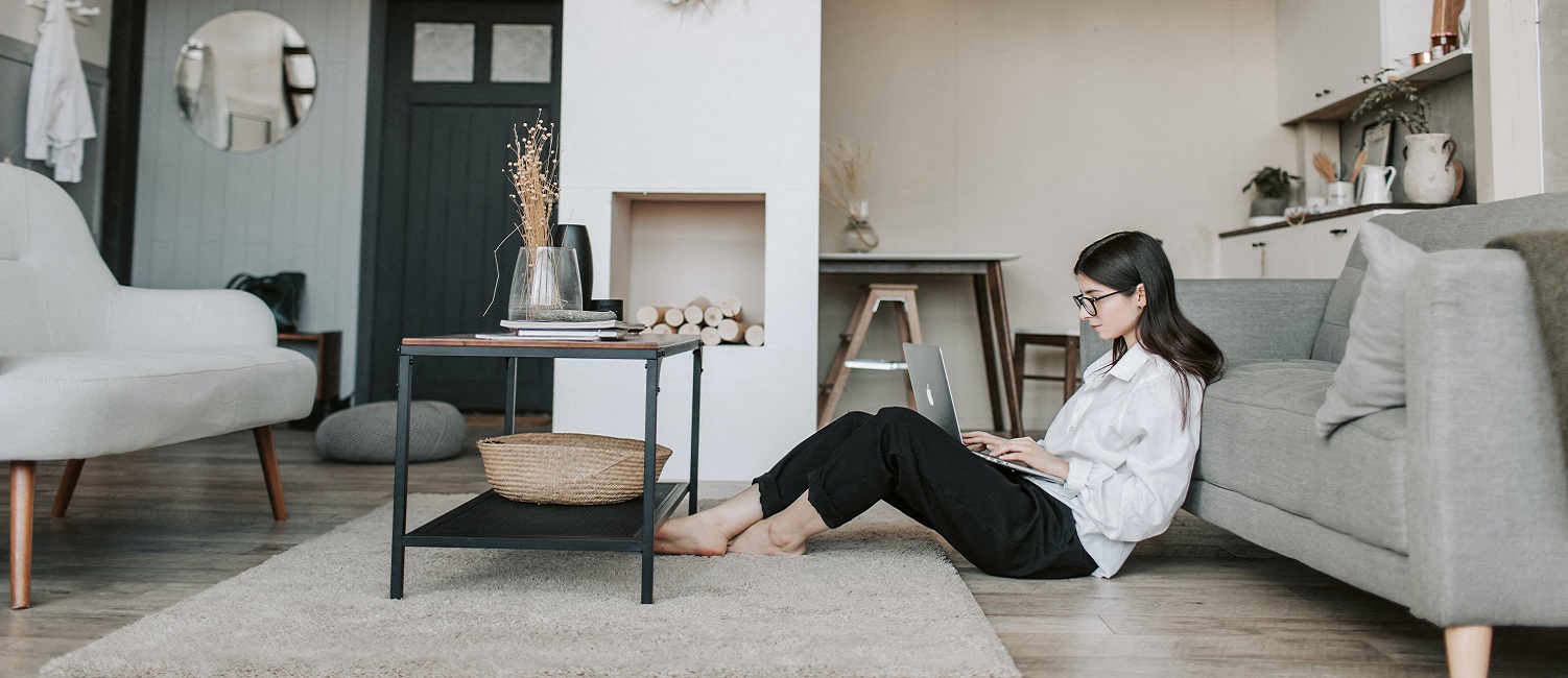 Student sitting beside couch