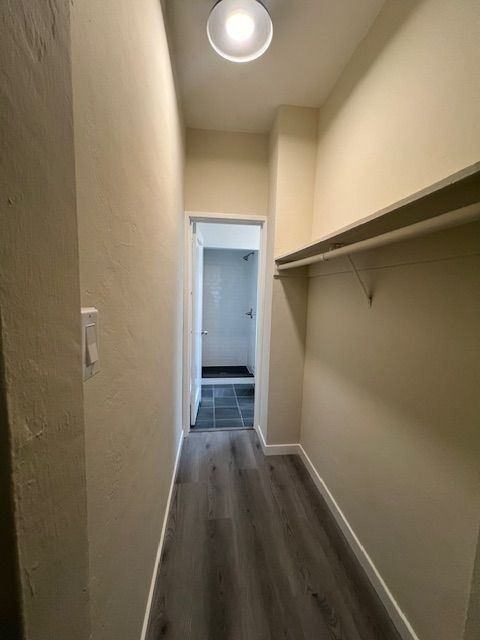 A hallway with a door at the end and a light on the ceiling.