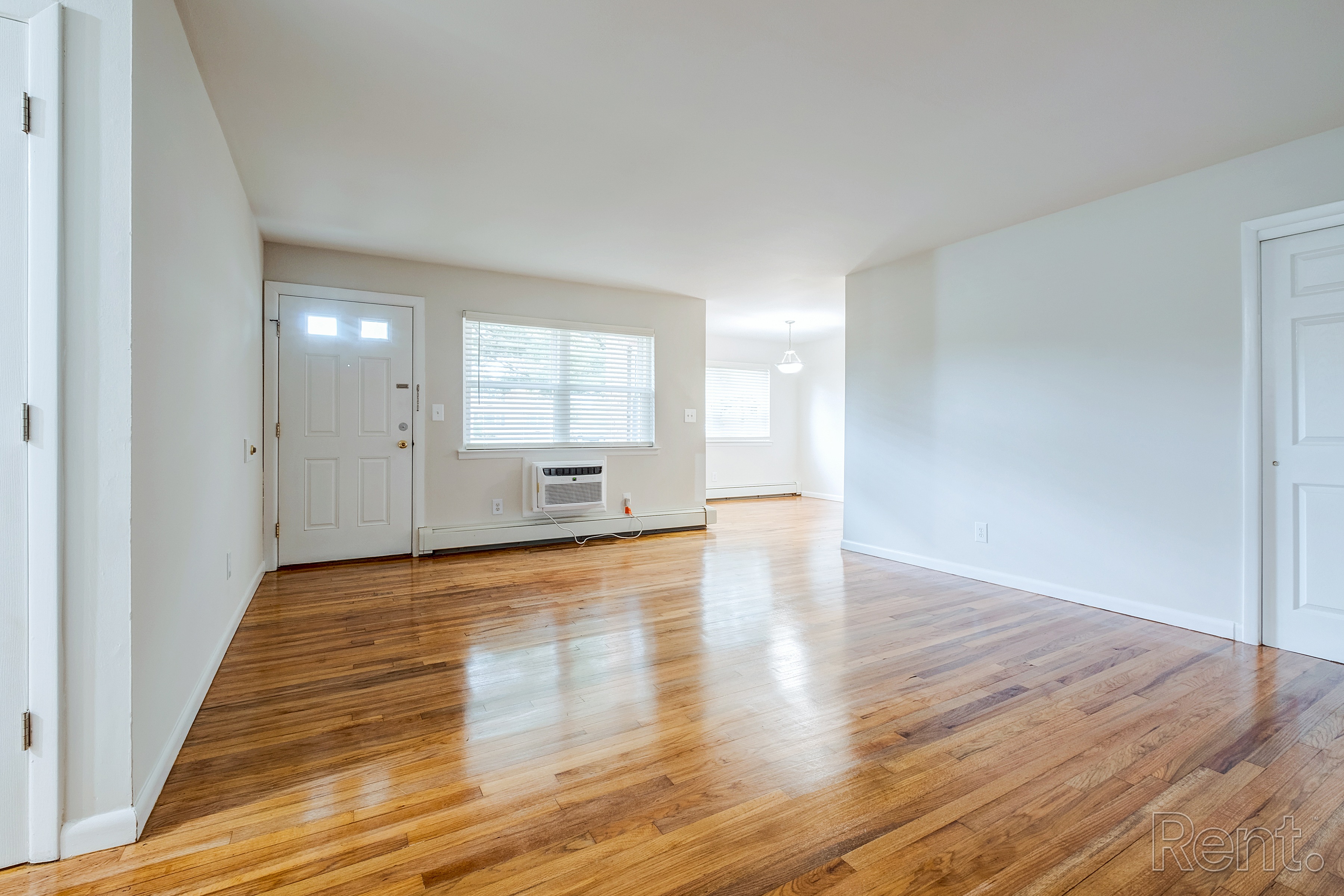 A room with wooden floors and white walls.