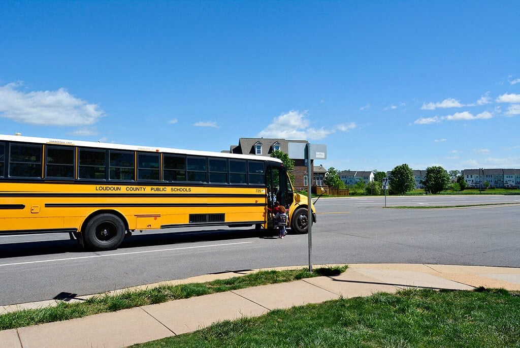 A yellow school bus is parked on the side of the road.