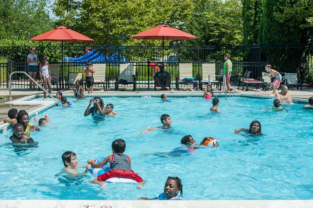 A group of people are swimming in a pool.