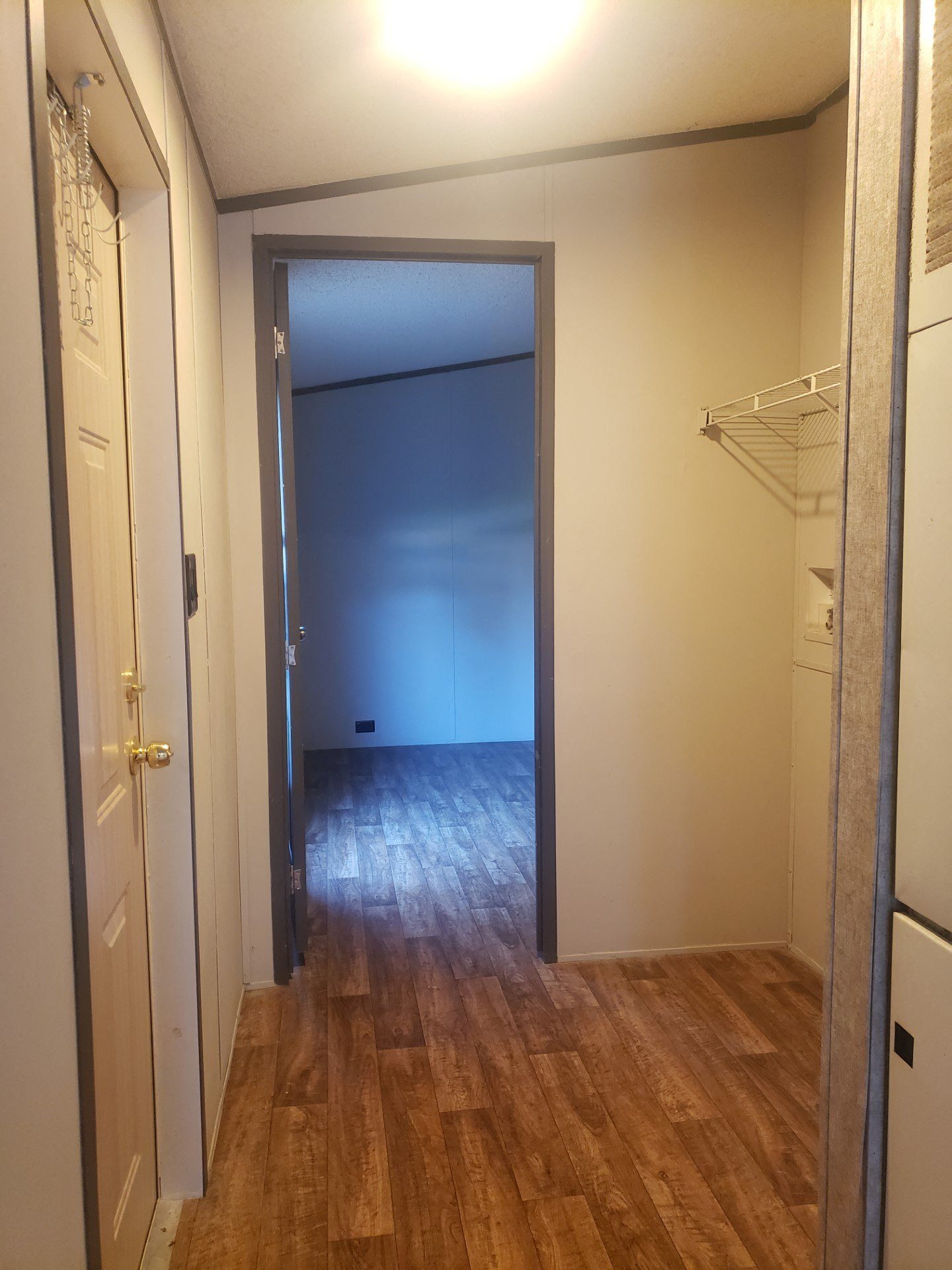 an empty room with a closet and a door open