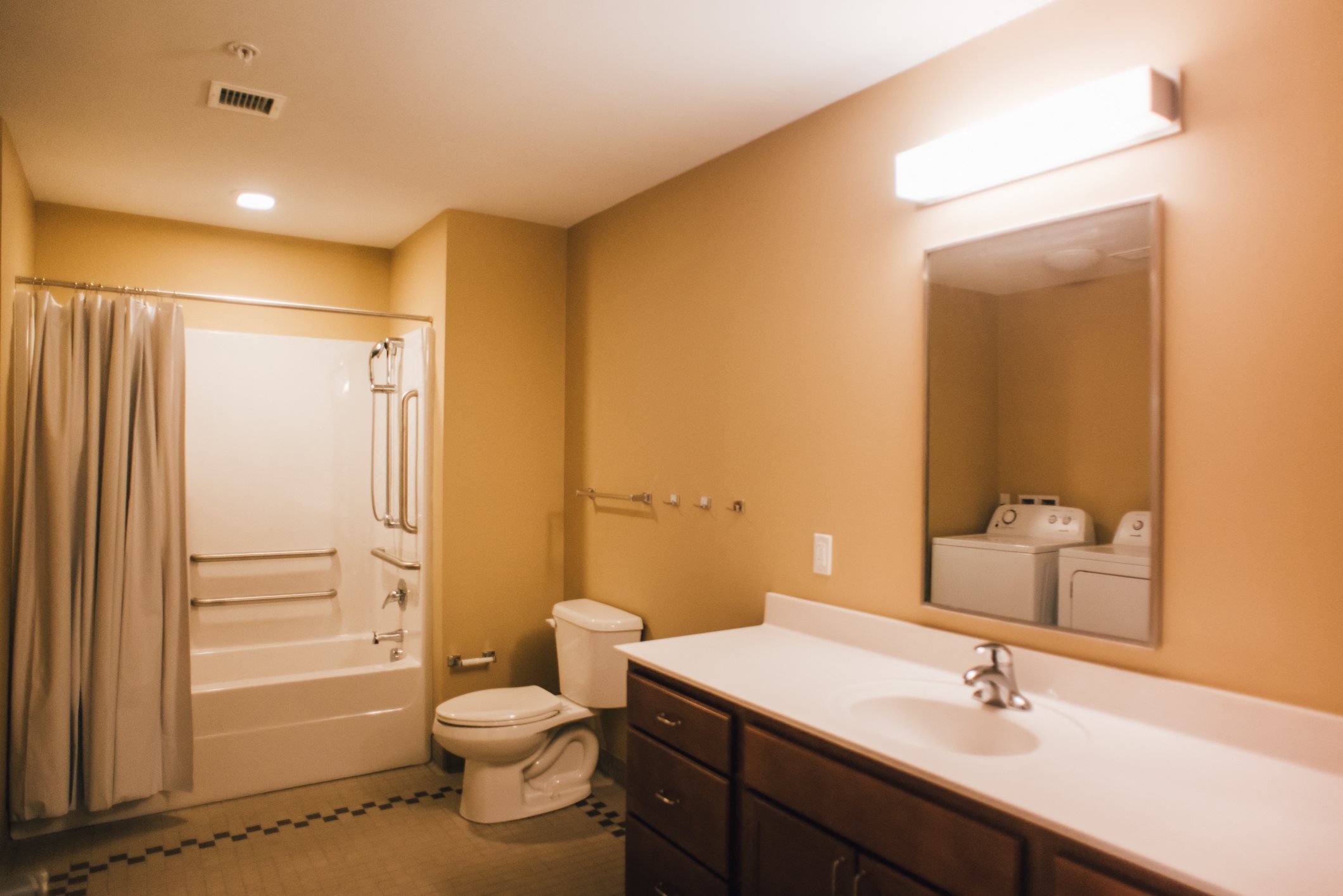 bathroom with dark vanity and white counter