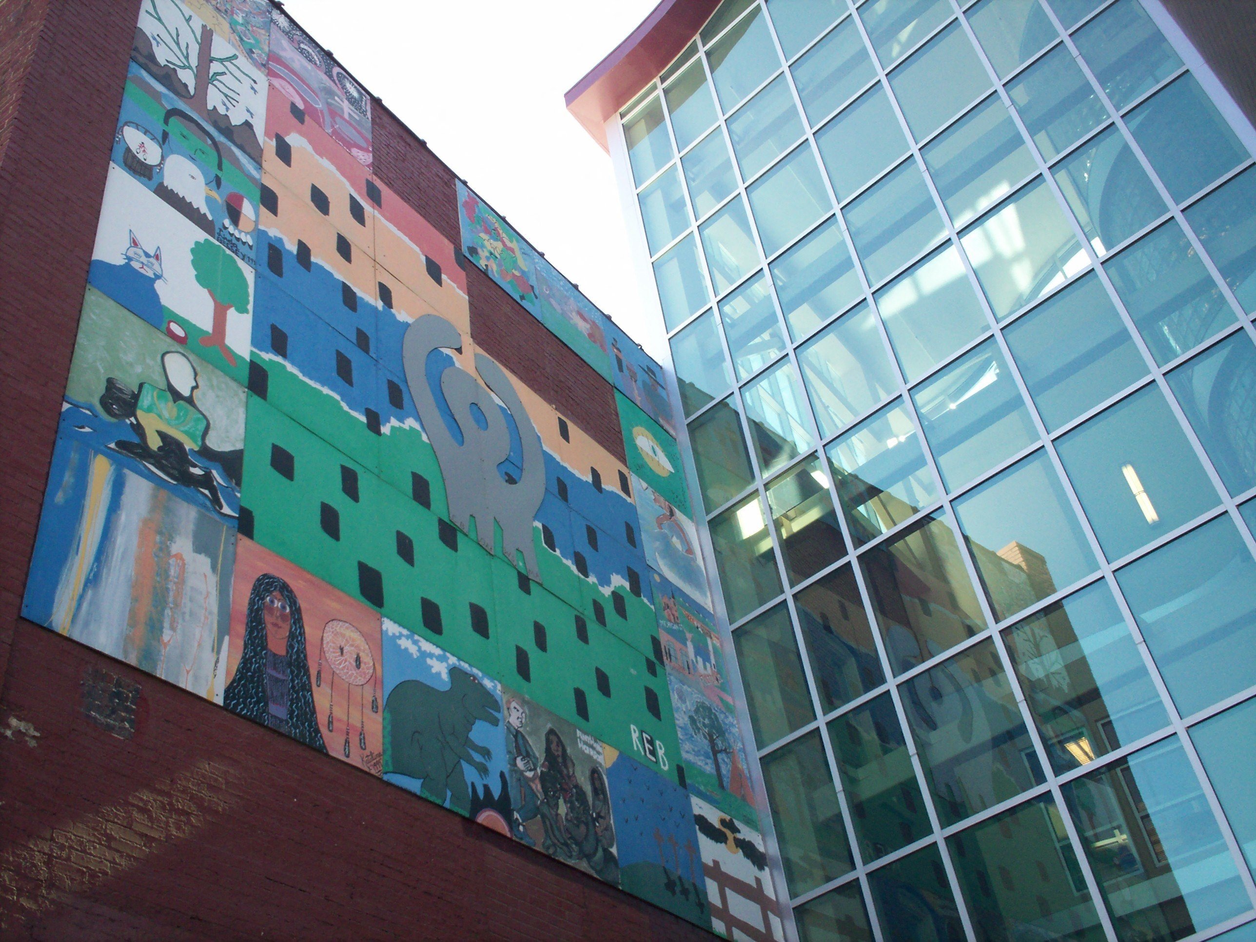 wall of windows and colorful mural