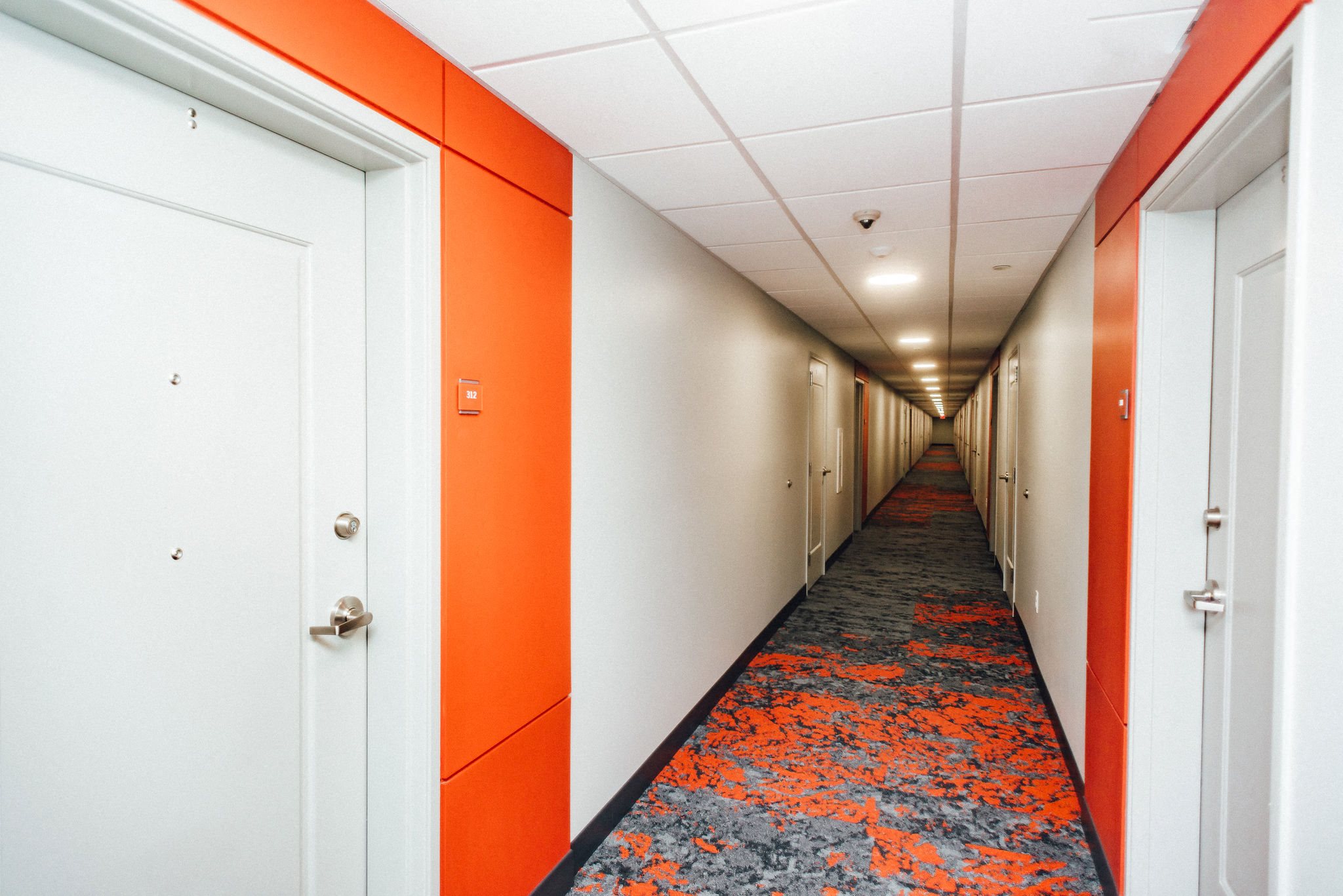 apartment hallway with orange walls