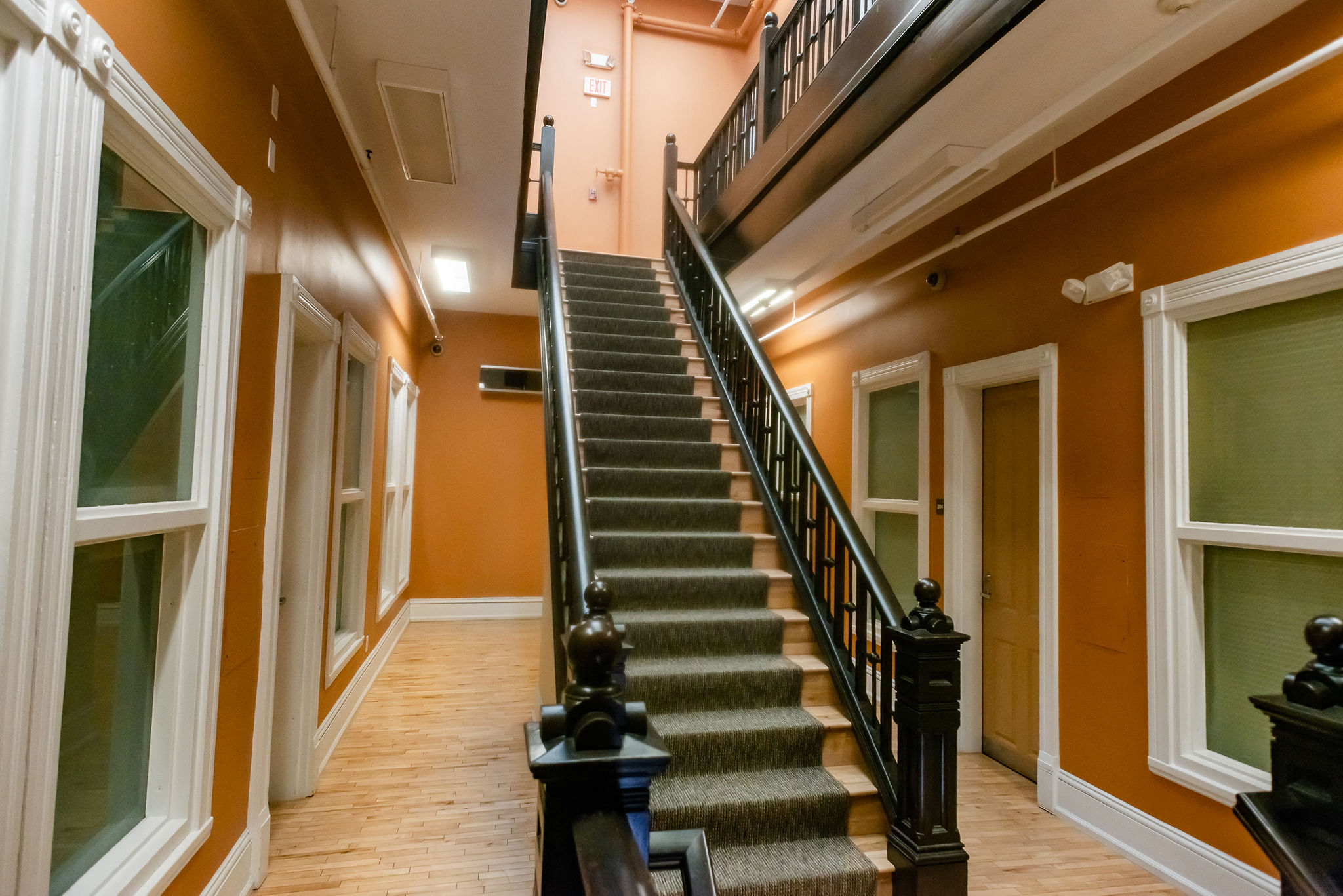 historic apartment stairway orange walls