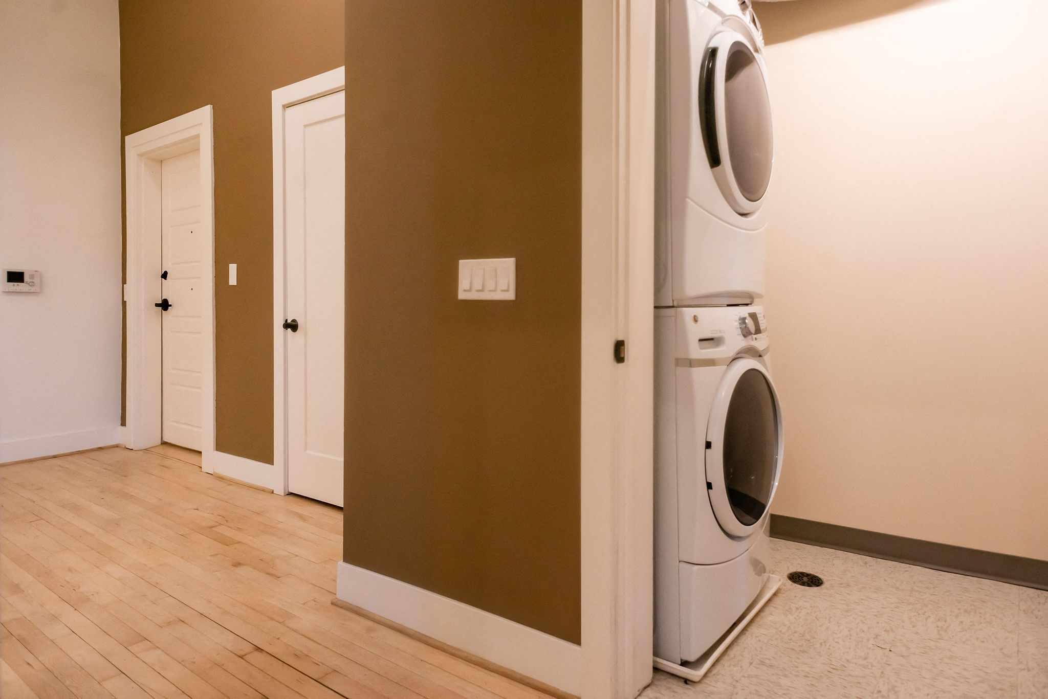 brown walls, lvp flooring, stackable washer/dryer combo