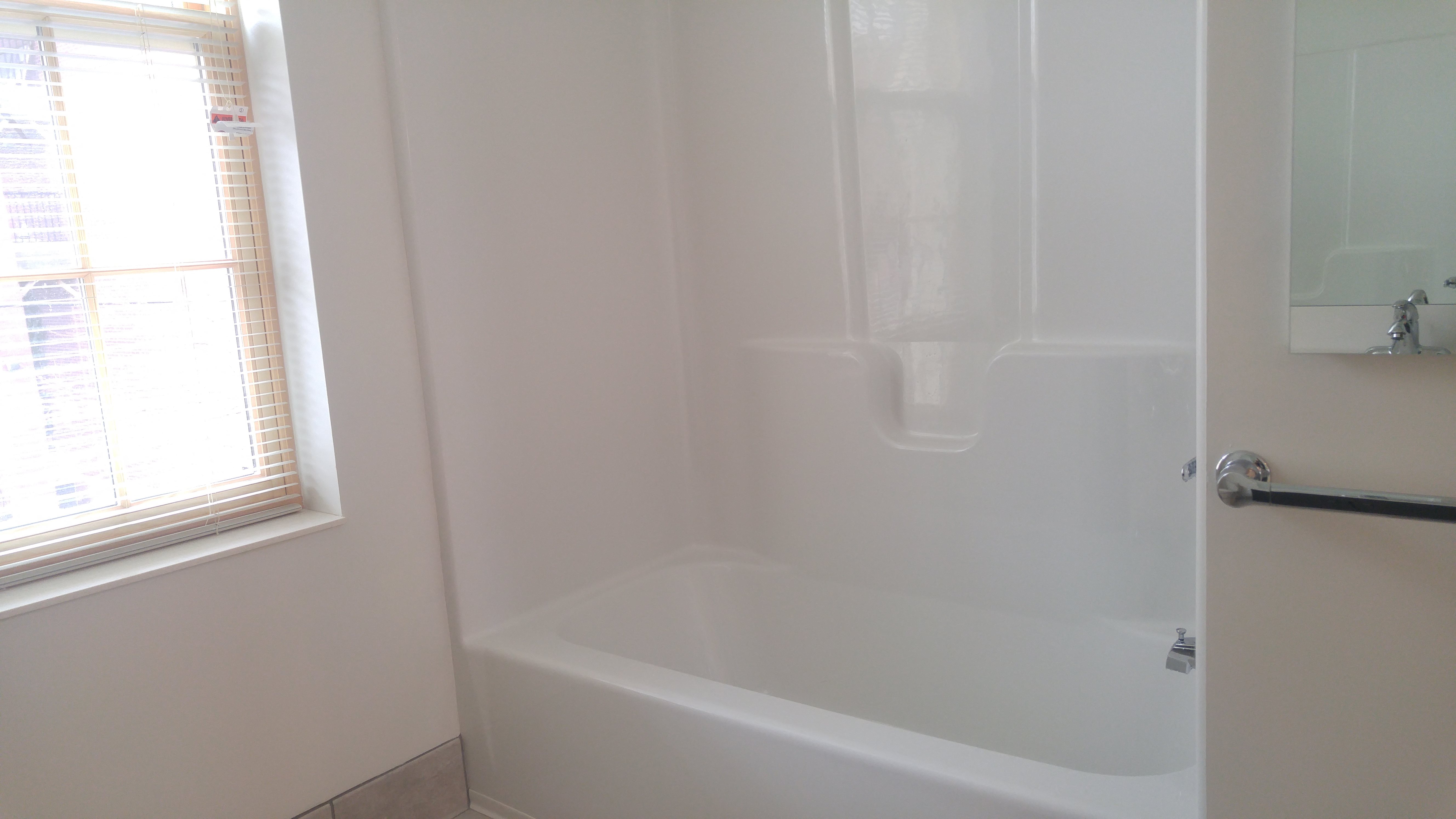 white bathtub insert apartment bathroom