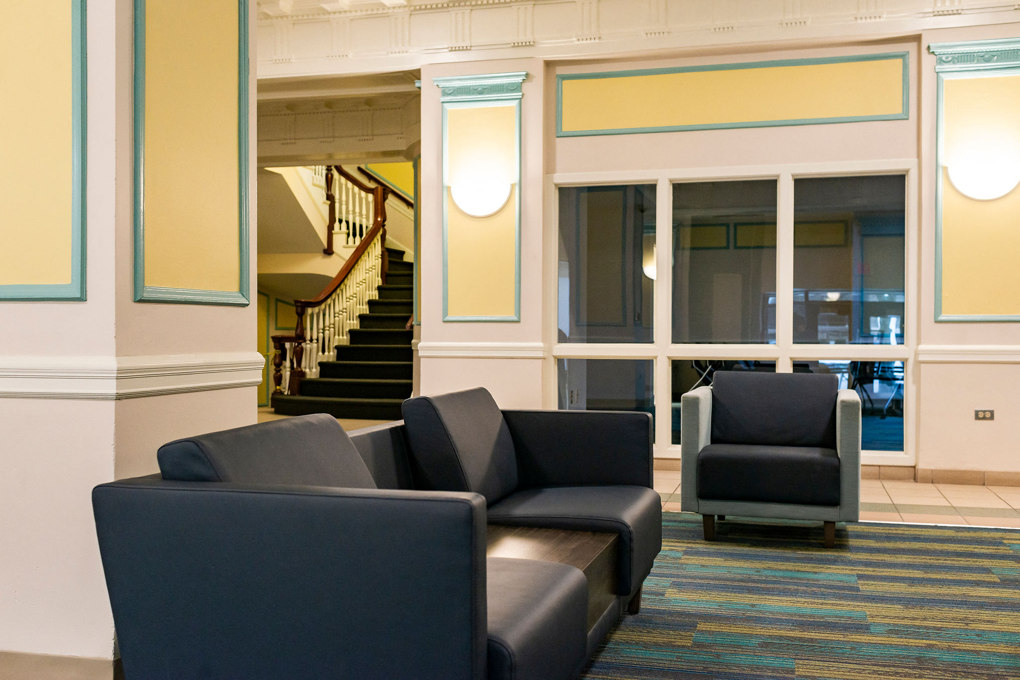 lobby with blue couch and decorative accents