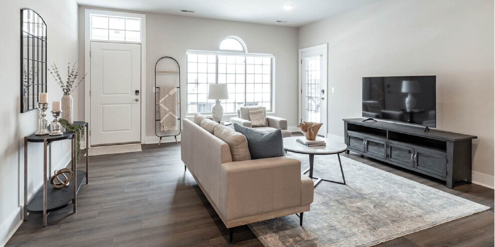 a living room with a tv and couches