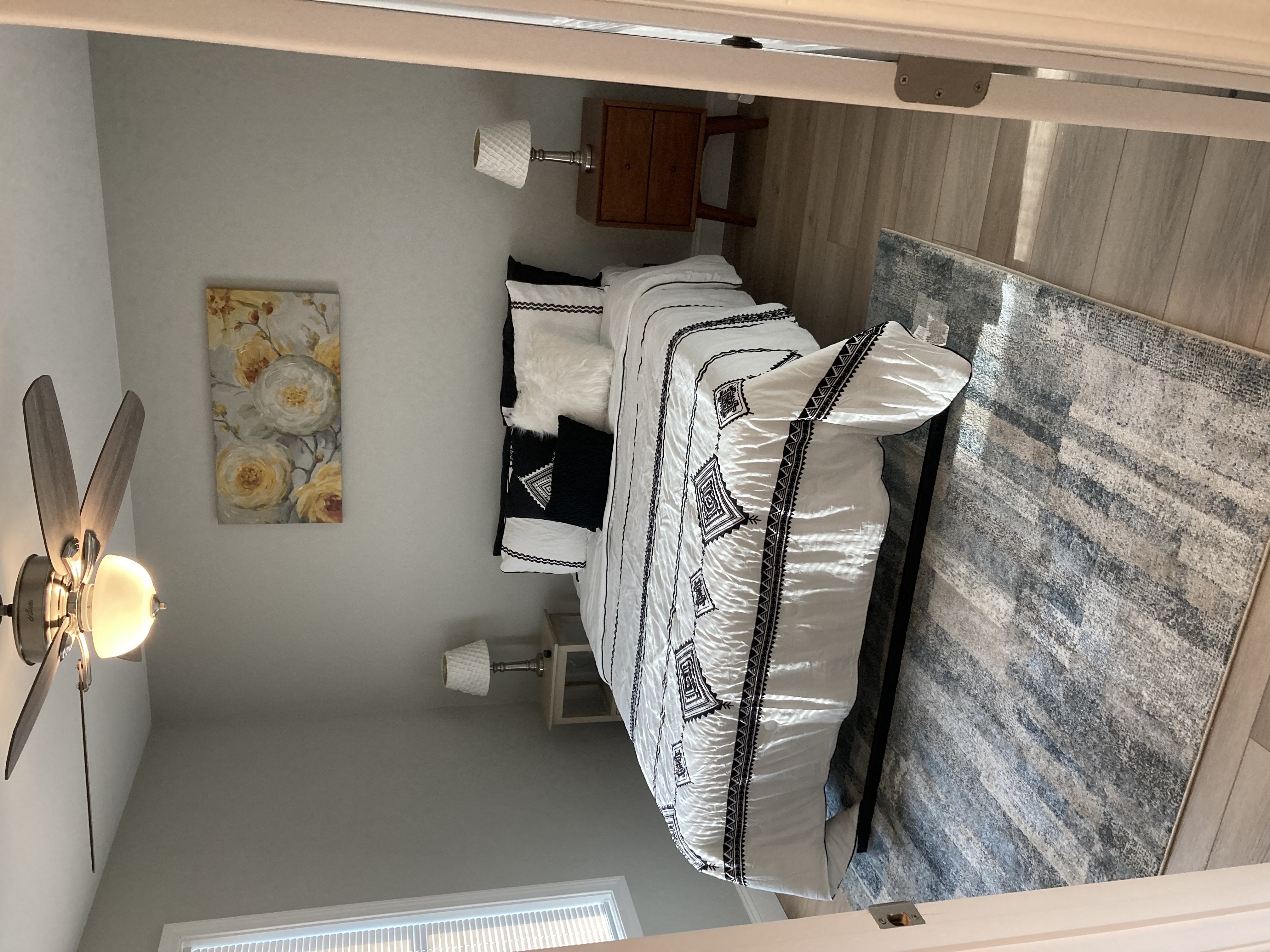 a small bedroom with a bunk bed and a mirror