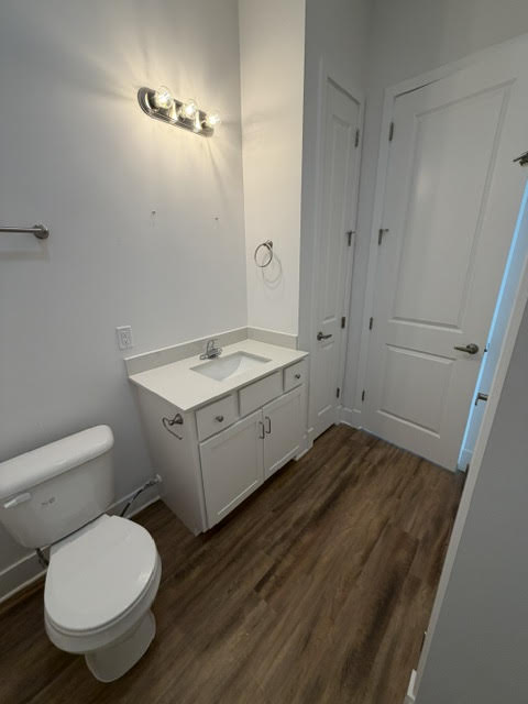 studio bathroom,A white toilet sits next to a white sink in a small bathroom.