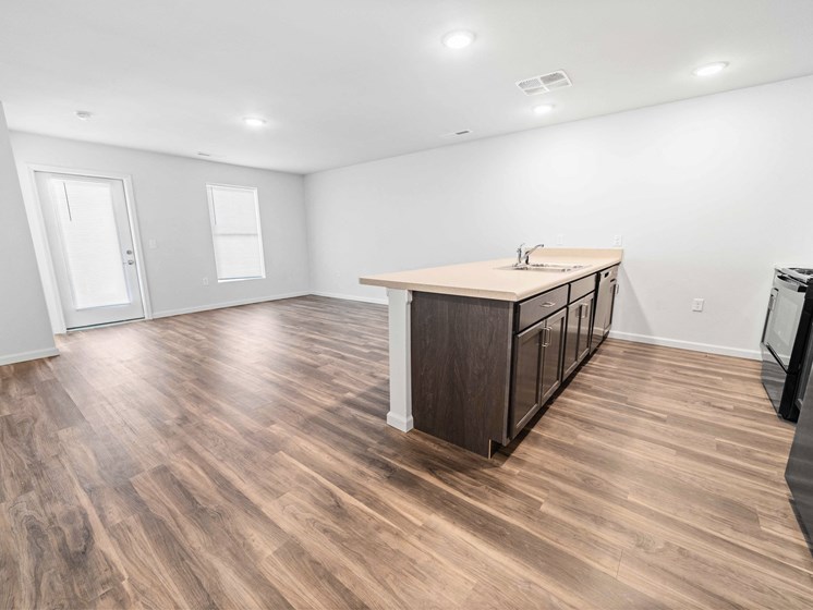a kitchen and living room with hardwood floors and white walls  at Union at Wiley, Cedar Rapids, IA, 52404