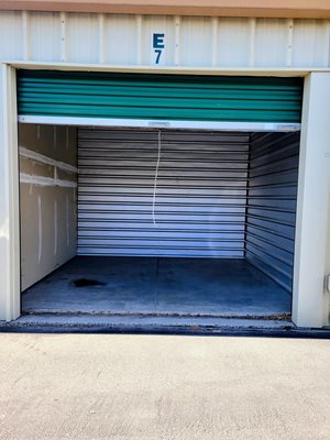 A garage door with the number 7 on it is closed.