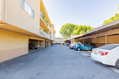 the view of a parking lot with cars parked next to a building