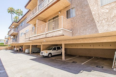an apartment building with a car parked in a parking garage