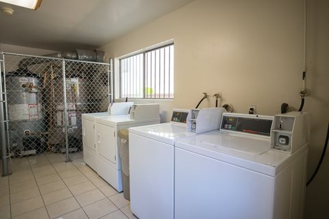 a laundry room with washers and dryers and a shower