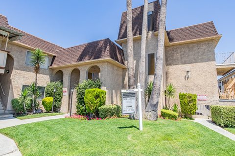 a house with a sign in front of a lawn