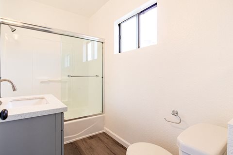 a bathroom with a toilet sink and a shower